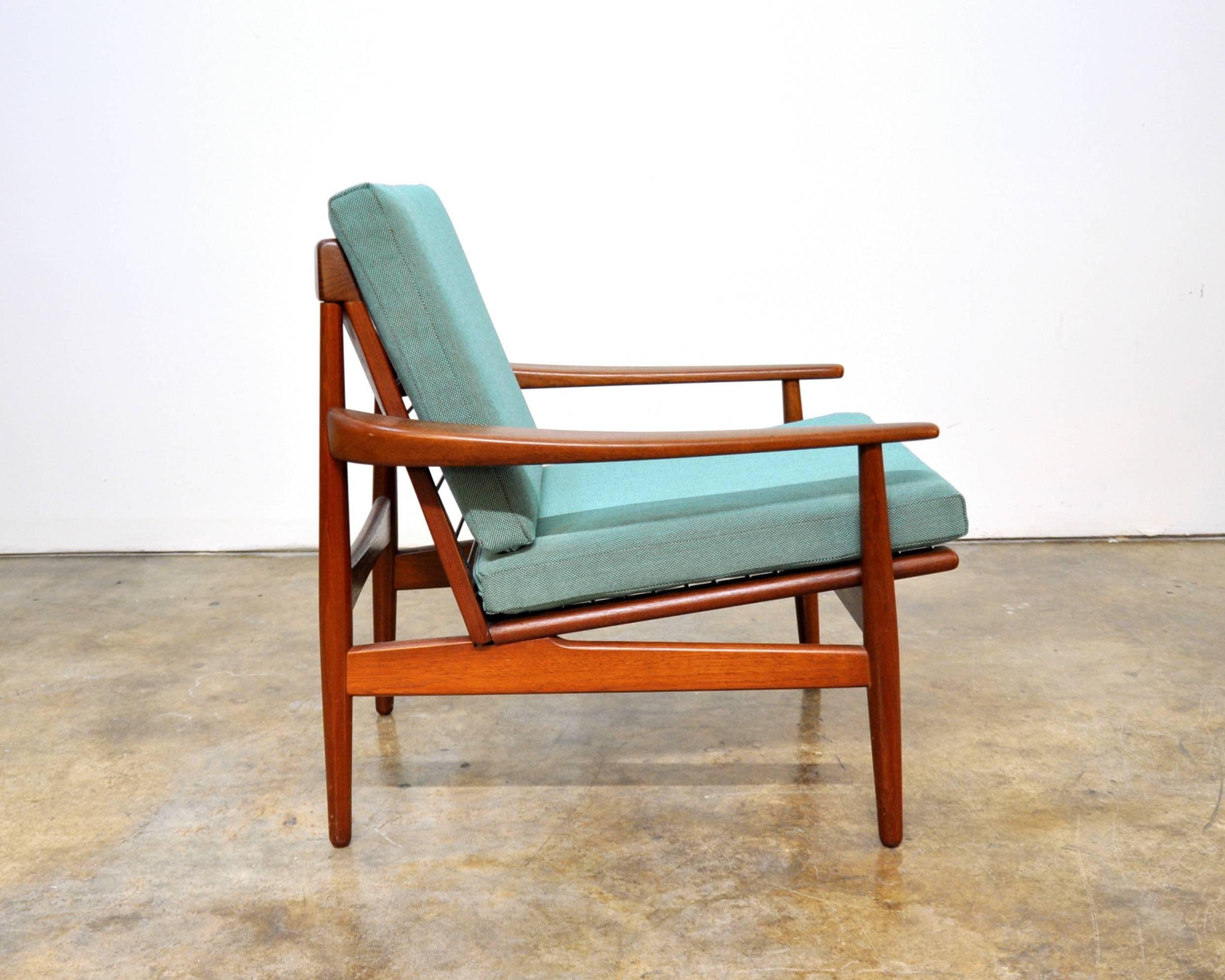 Vintage Danish modern Mid-Century teak easy chair manufactured by Glostrup Mobelfabrik in the early 1960s. The removable cushions have been recovered in Steelcut Trio Kvadrat fabric. The upholstery is turquoise with brown undertones. The solid teak