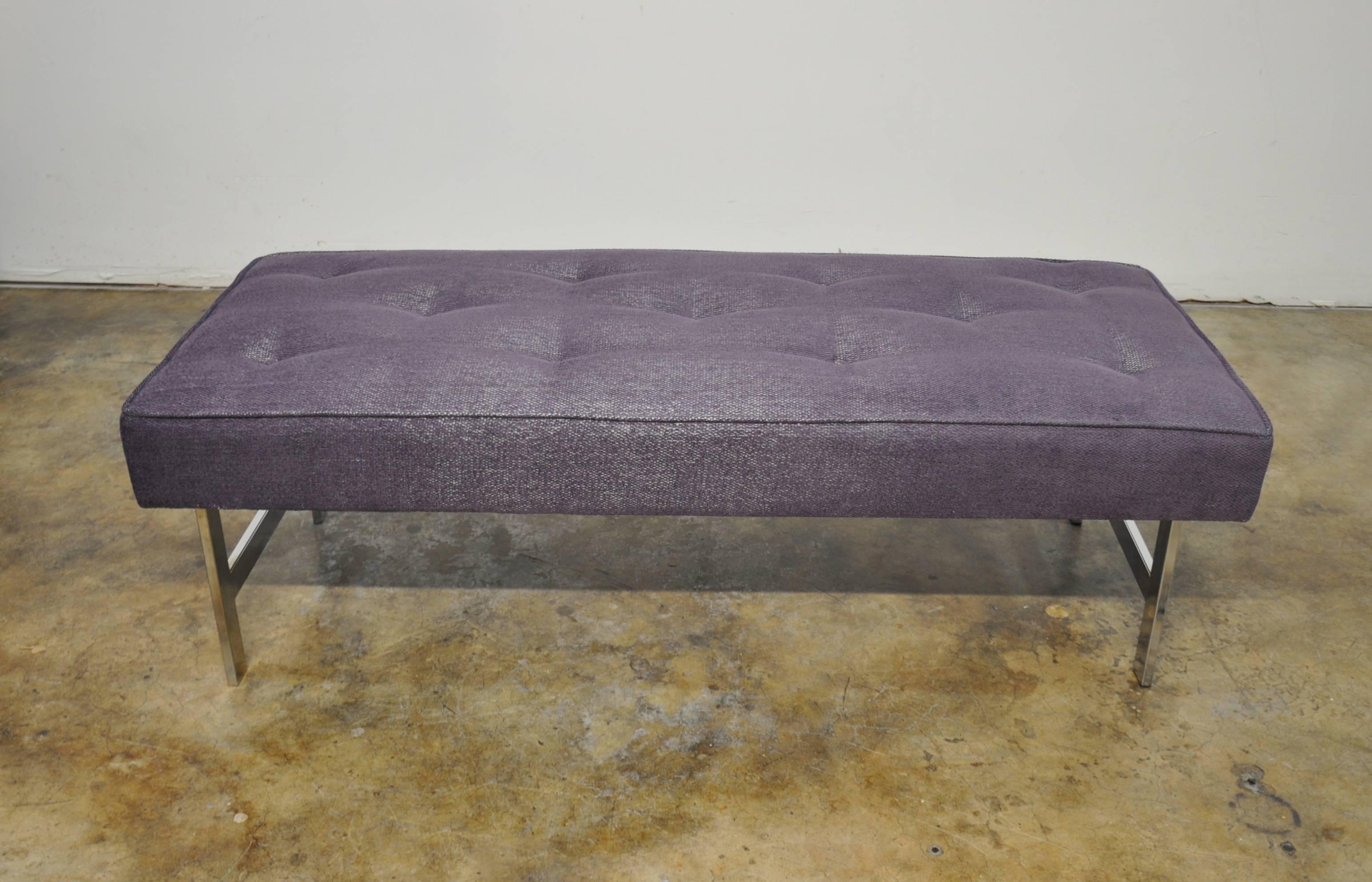This decorative vintage long ottoman features chrome legs and tufted seat. It has been reupholstered in a light plum with silver undertones chenille. Great size that can work virtually anywhere: At the foot of a bed, in an entrance, as a sofa or
