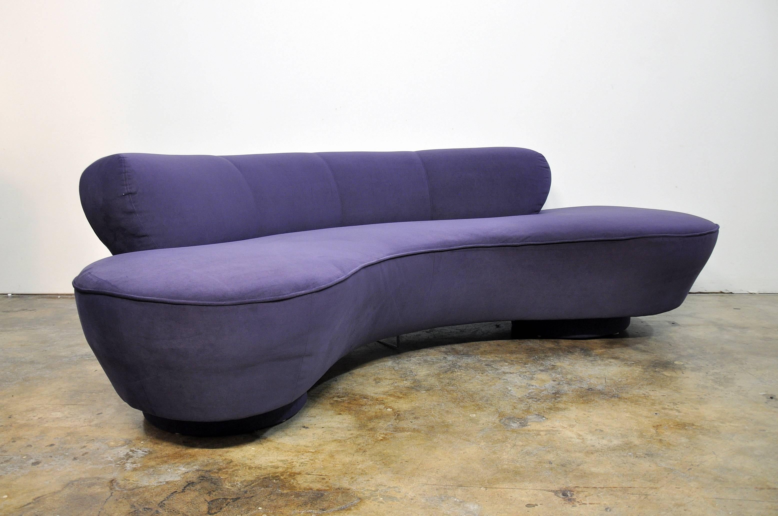 Iconic biomorphic sofa in original eggplant ultra-suede. Features a kidney or cloud shape with round upholstered bases and Lucite fin. The deep purple suede fabric is very soft to the touch. This timeless Classic is a one owner beauty that will