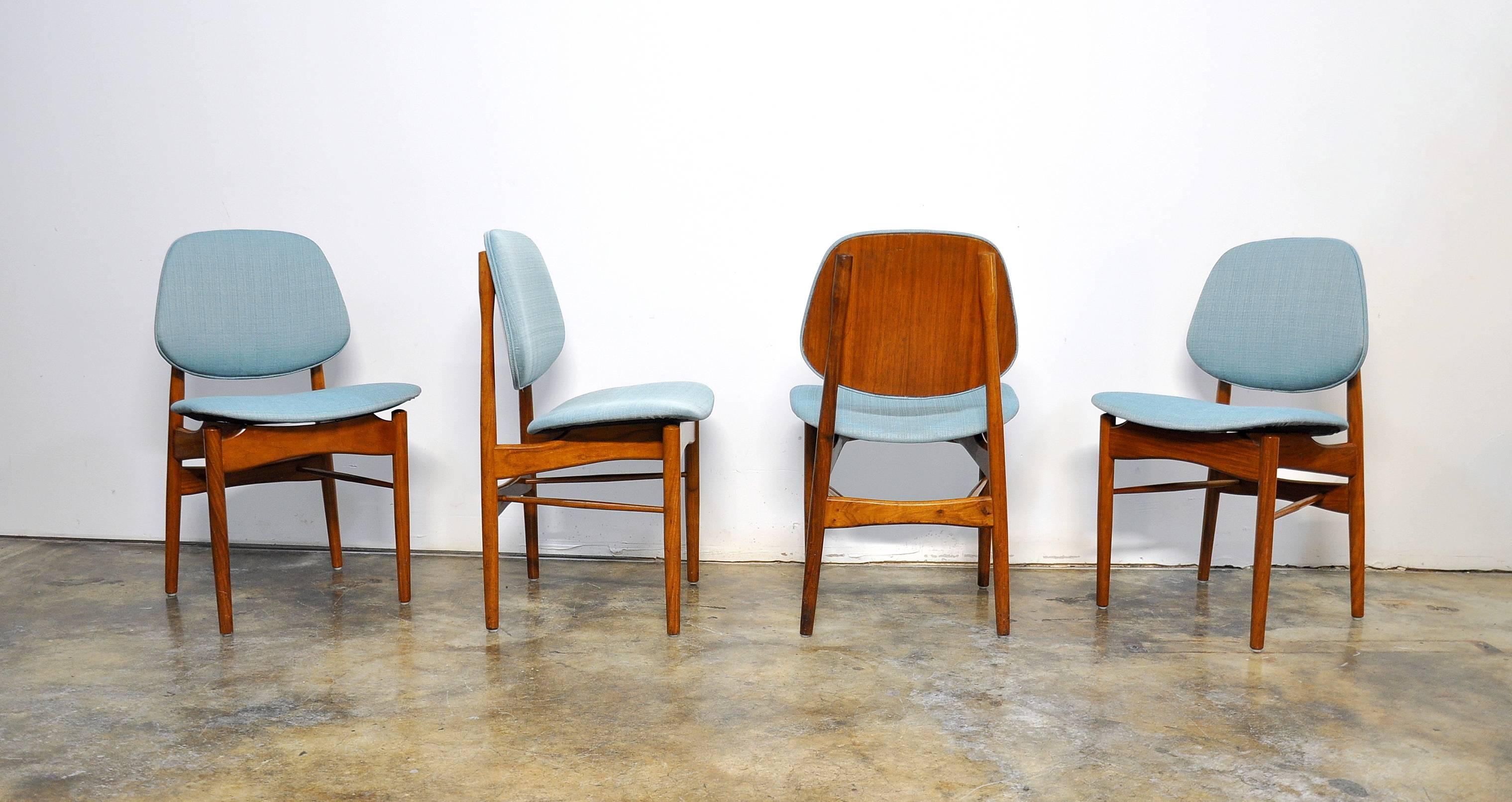 Rare and early set of Mid-Century teak dining chairs with floating seats and curved backrests, typical of Finn Juhl's designs. The frames are in original condition with rich patina and have been newly fitted with a light turquoise fabric. The chairs