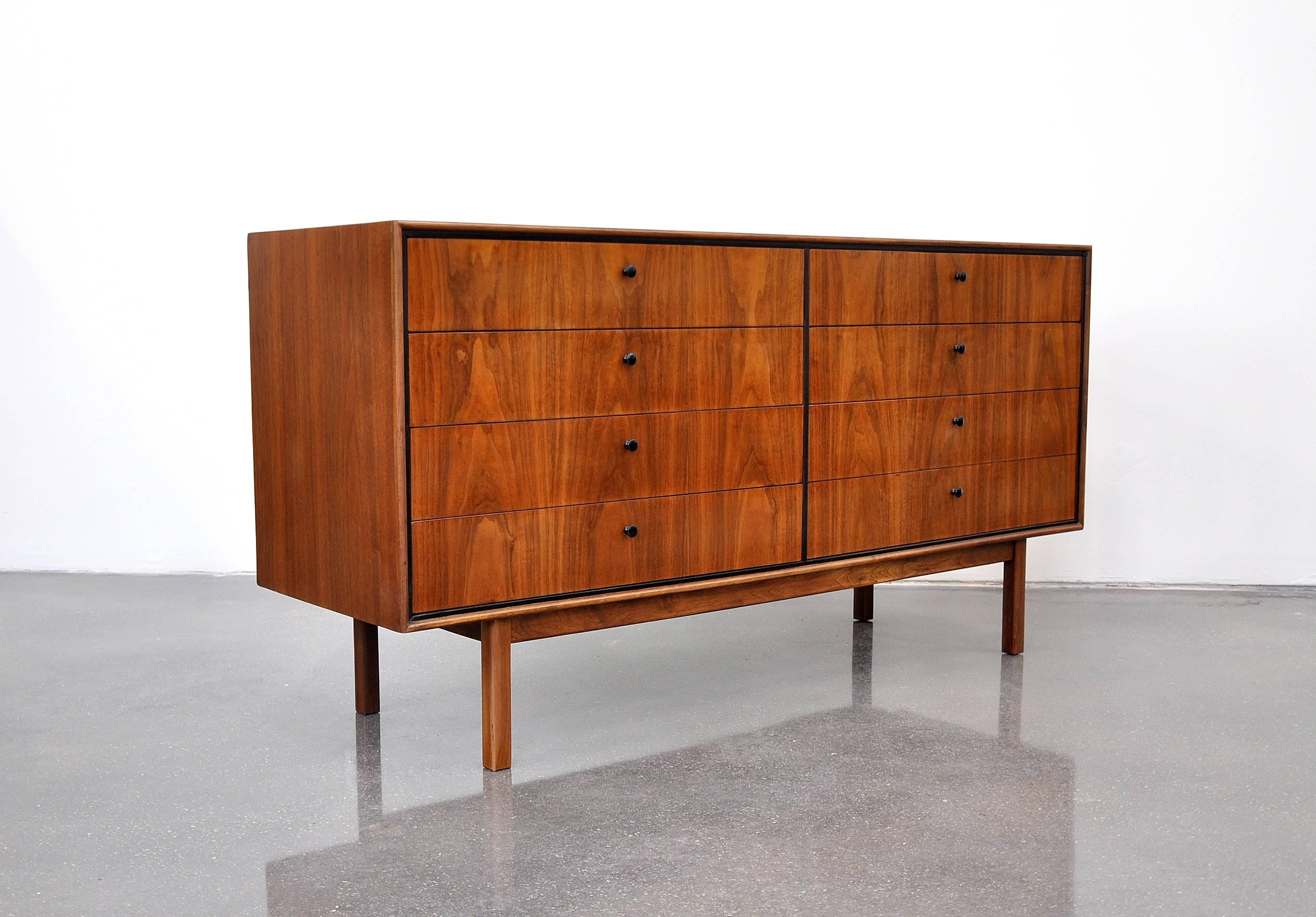 Early and rare Mid-Century Modern bedroom set with a vintage double dresser and a pair of night stands designed by Milo Baughman for Arch Gordon in the 1950s. Professionally refinished, the beautifully grained walnut boasts striking patterns. The