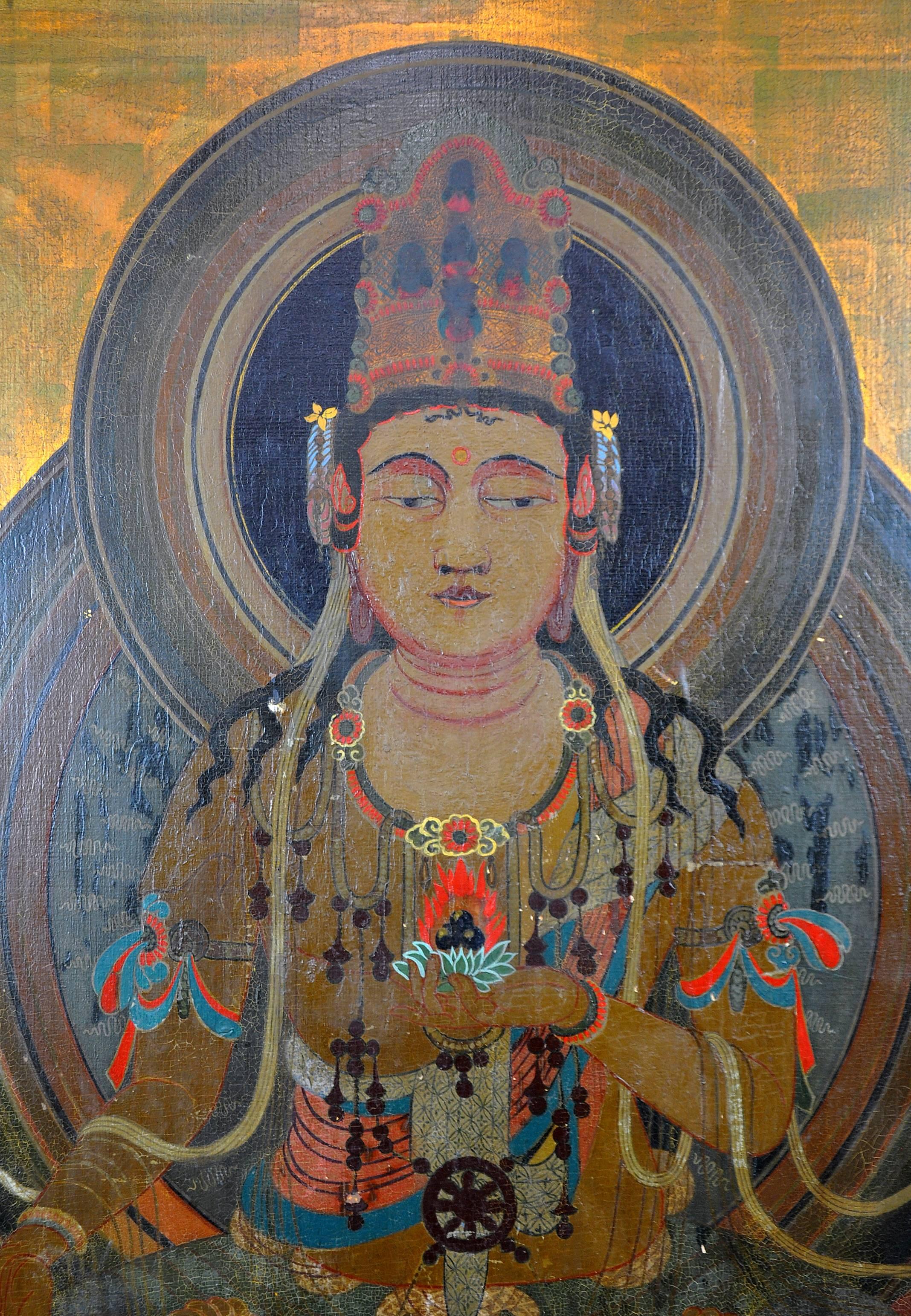 Very striking larger oil painting on canvas laid down on Masonite with gilt background depicting Buddha in a seated position on a giant lotus flower. The flower represents a symbol of fortune, meaning rising and blooming above the murk to achieve