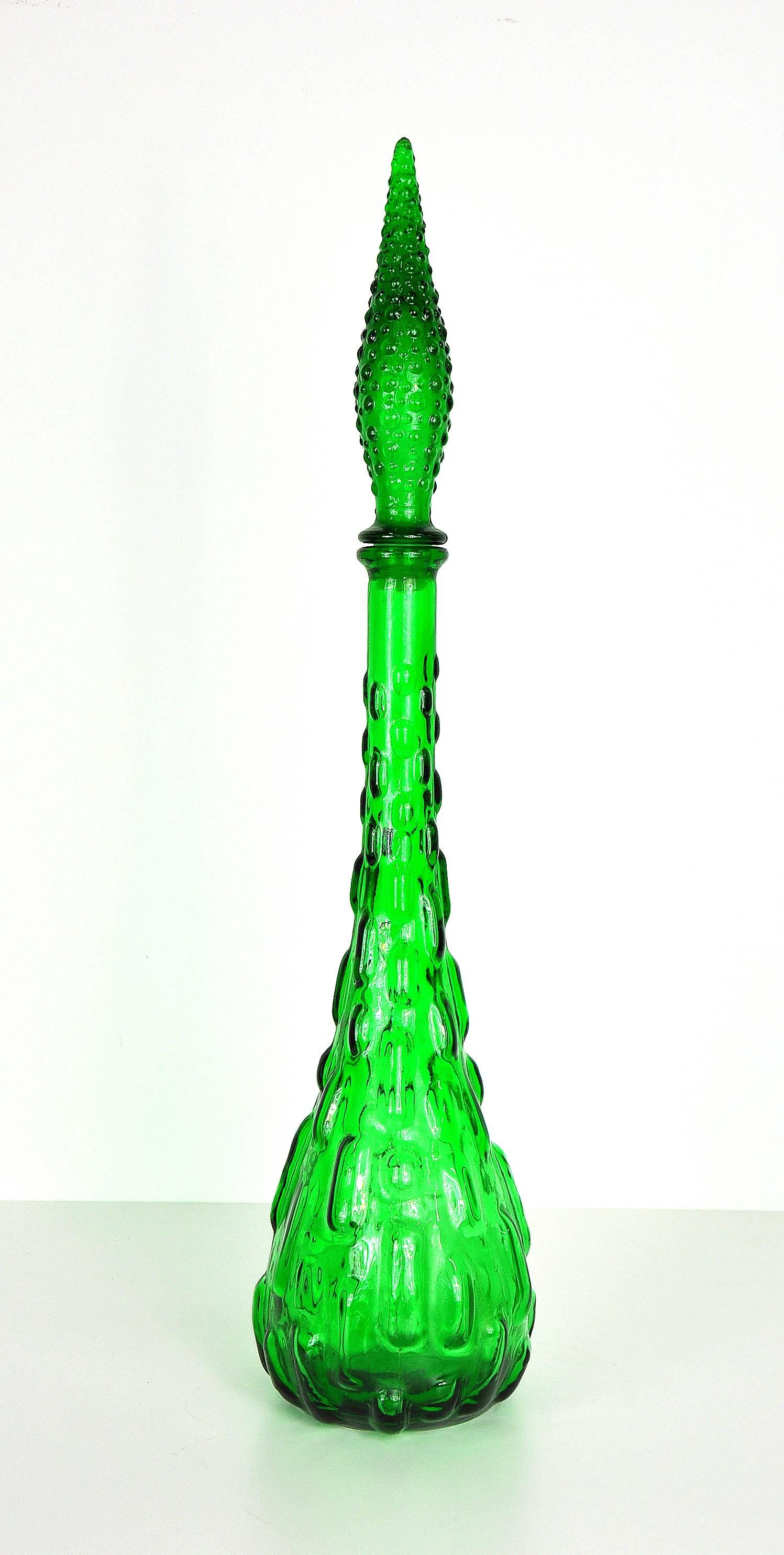 This vintage Italian Mid-Century Modern large glass genie bottle features a raised bubble pattern and a rich and mesmerizing emerald green color. Manufactured by Rossini, it dates from the 1960s. Quite tall and very decorative! Marked made in Italy