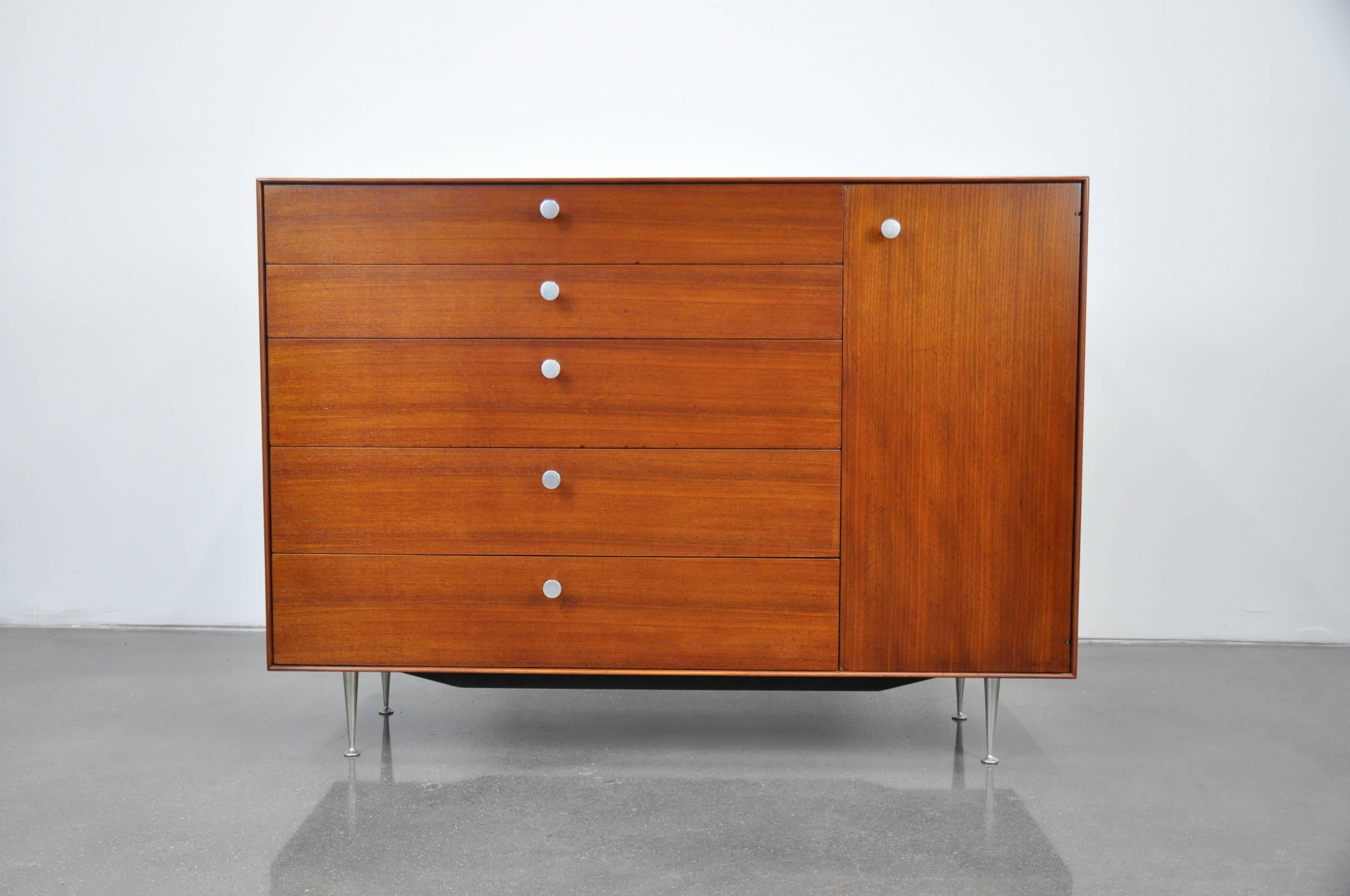 Superb Mid-Century American Modern dresser cabinet model 5245 from George Nelson's Thin Edge series that was first produced by Herman Miller in 1952. The chest features five drawers of graduating sizes flanked by a one credenza style door opening to