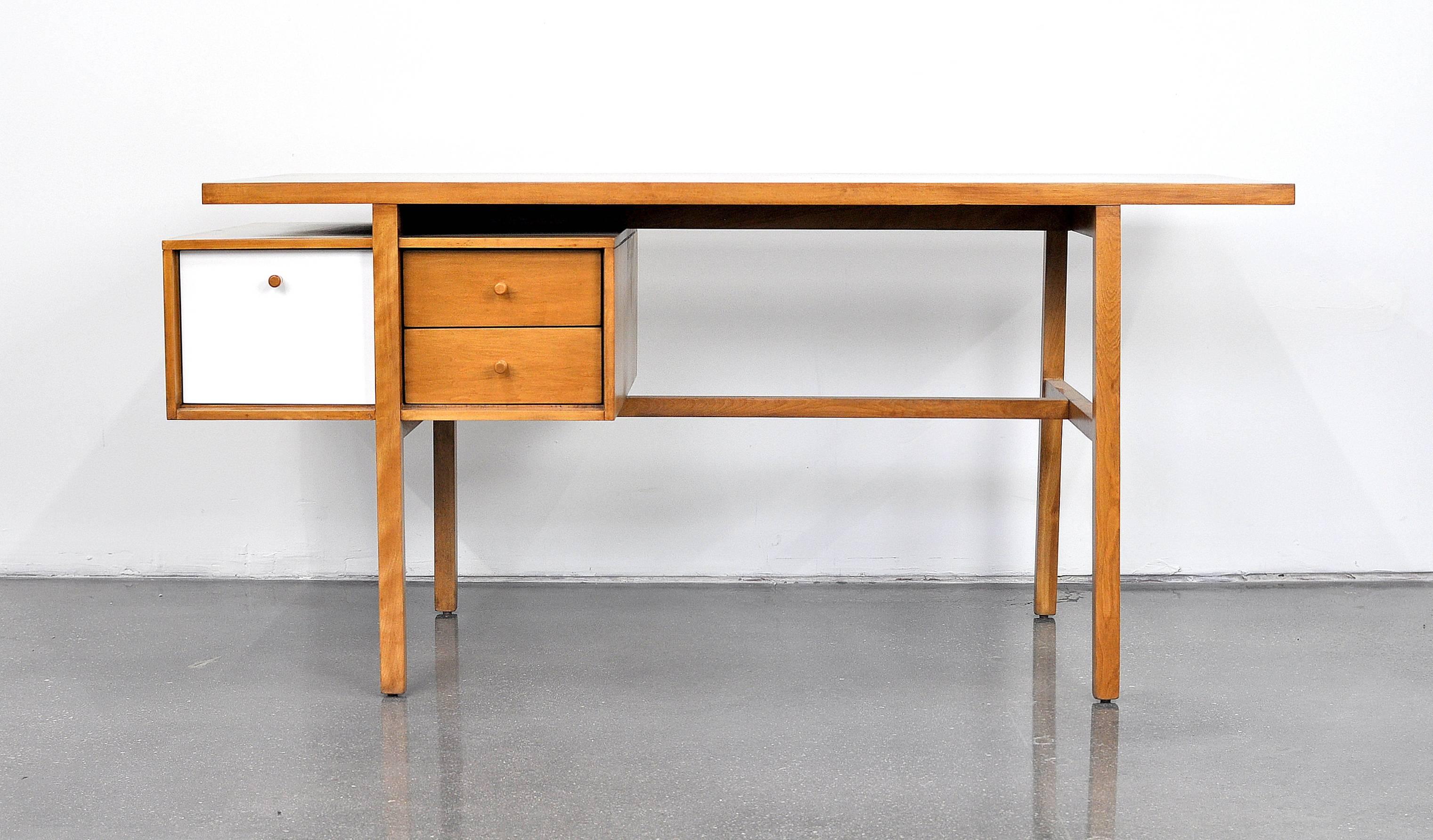 A rare example of the Mid-Century Modern model 3116 desk from the Milo Baughman collection for Murray Furniture of Winchendon, MA., dating from the mid-1950s. The collection was introduced in 1952, and the writing table in 1954. It features a