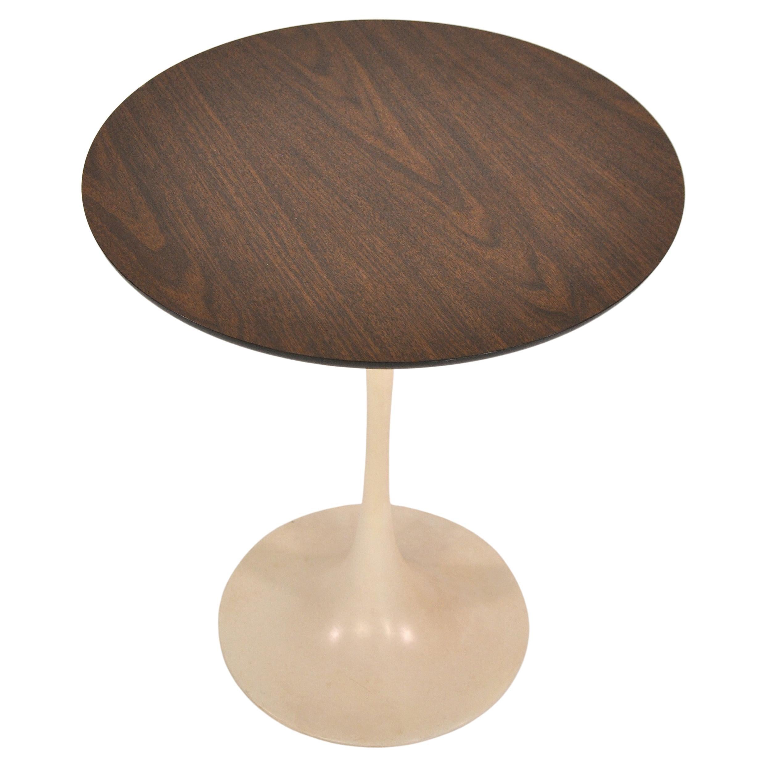 A vintage 1960s Mid-Century Modern Tulip occasional table designed by Eero Saarinen for Knoll. The round tabletop features a walnut with clear laminate coating that Knoll only produced for a very short time due to high production costs. It allows