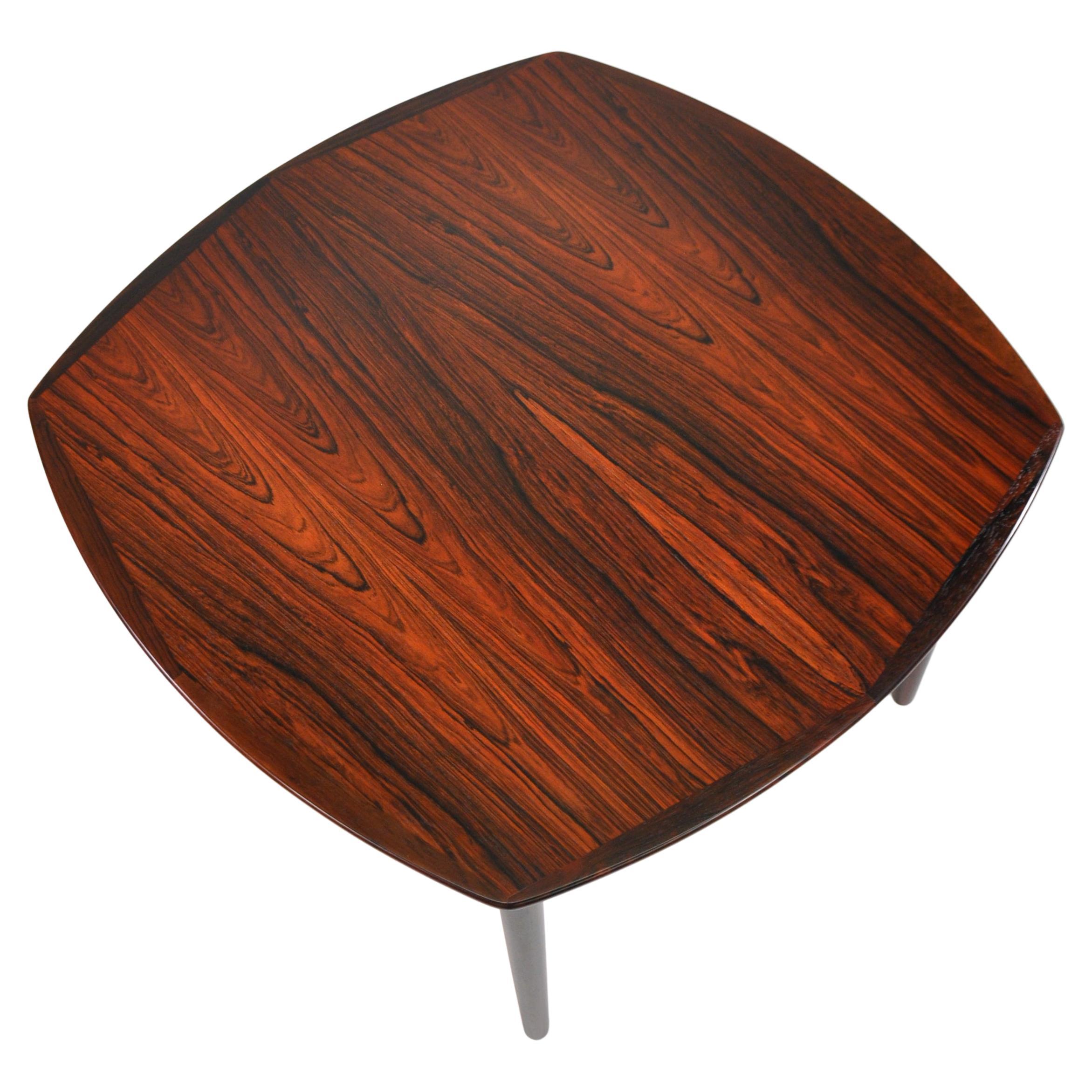 Gorgeous mid-century Scandinavian Modern Brazilian rosewood dining table, by Adolf Relling and Rolf Rastad for Gustav Bahus in the 1960s. The table seats four when compact and extends to accommodate six with one leaf, or a dinner party of eight or