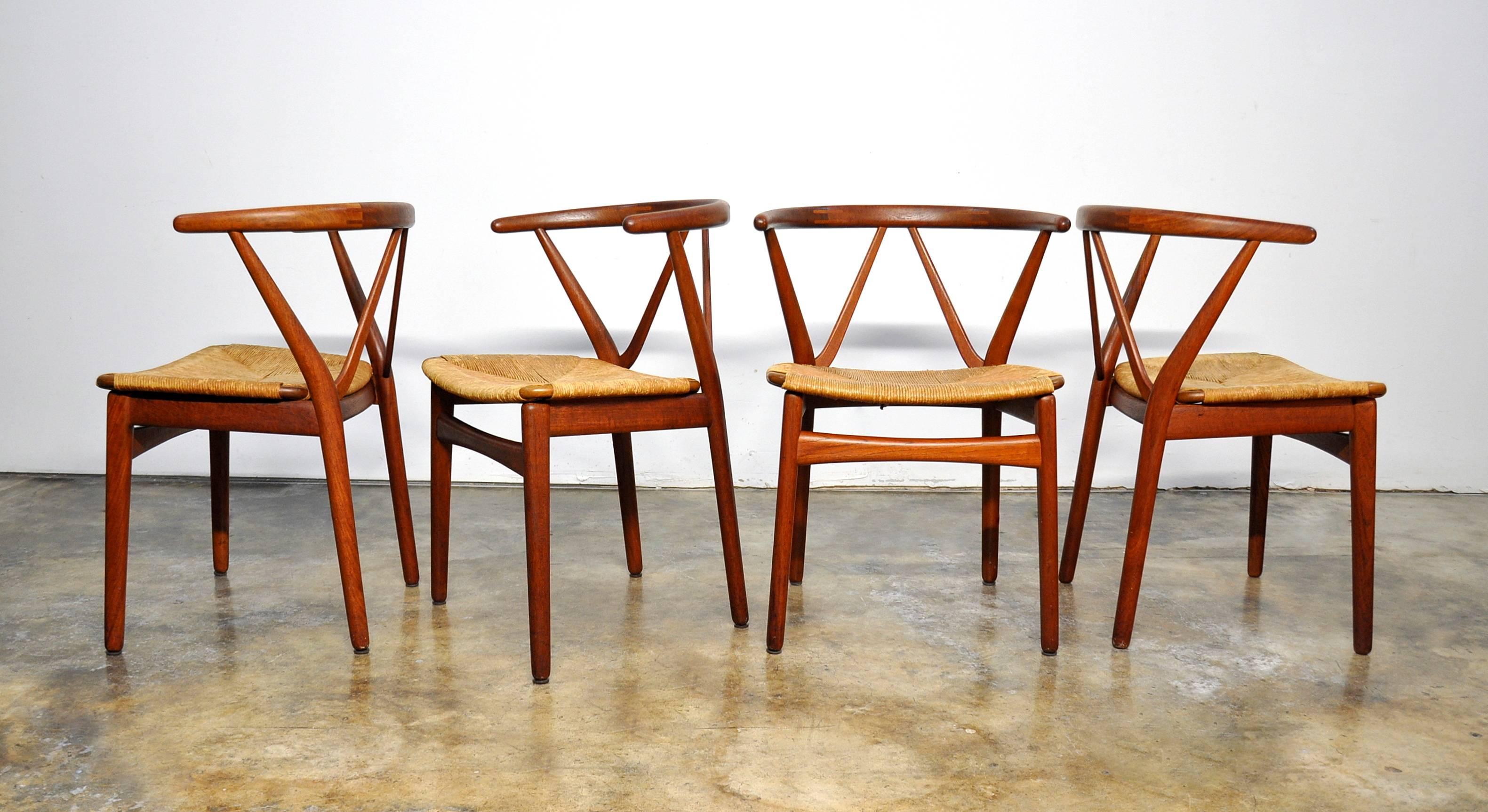 Rare set of all original mid-century Danish modern chairs with a remarkable design that looks truly outstanding from every angle. The chairs are vintage and date from the early 1960s. The curved backrests feature visible biscuit joints and provide a