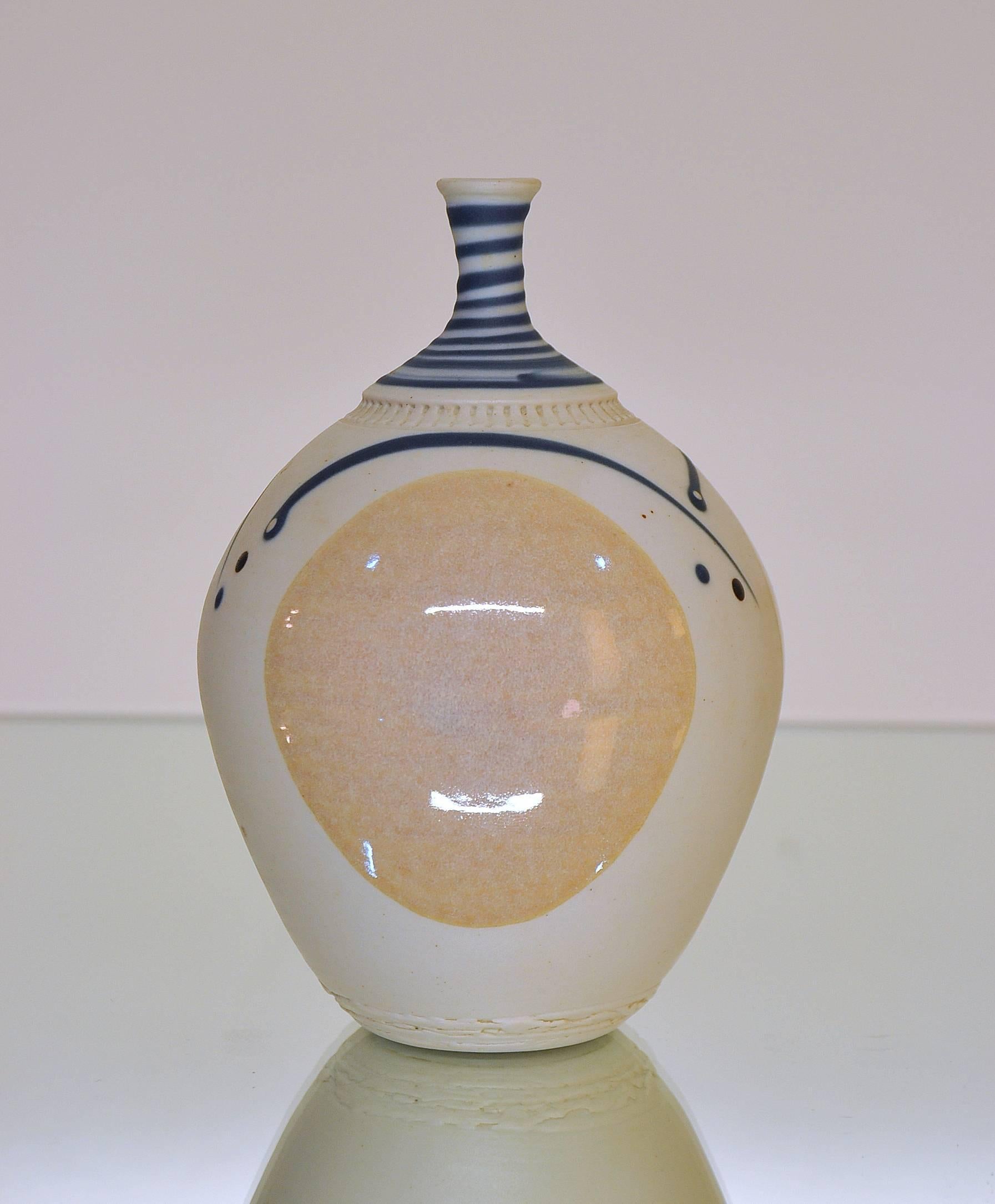 Rare and very fine mid-century modern bottle shaped example with pale iridescent peach partially glazed cream colored body. The vase is further decorated with stylized dark blue lines and dots. Bottom bears incised signature.