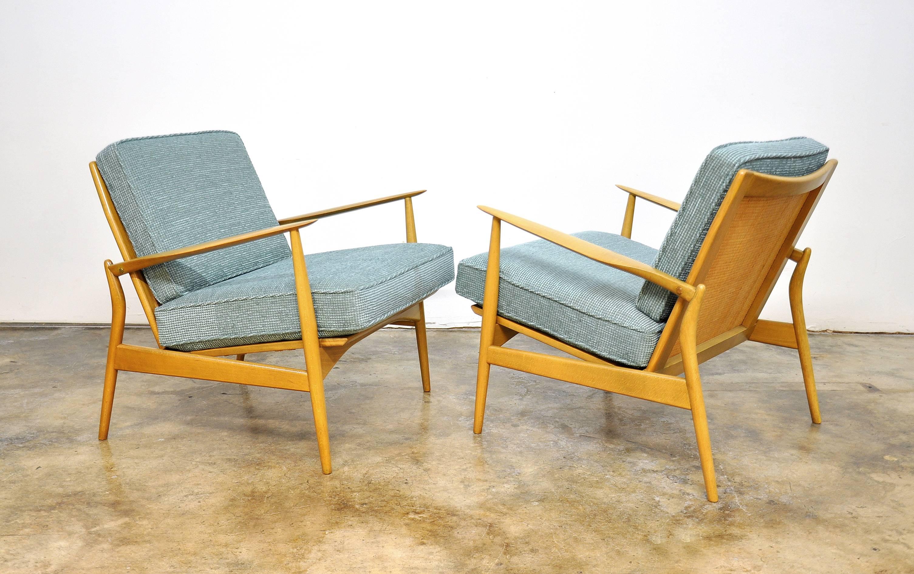 Early pair of the marvelous mid-century Danish modern Selig model #544-15 easy chairs, dating from the 1950s. They are instantly recognizable by their spear shaped arms, caned back and angled back legs. Newly reupholstered in a fabulous chenille,