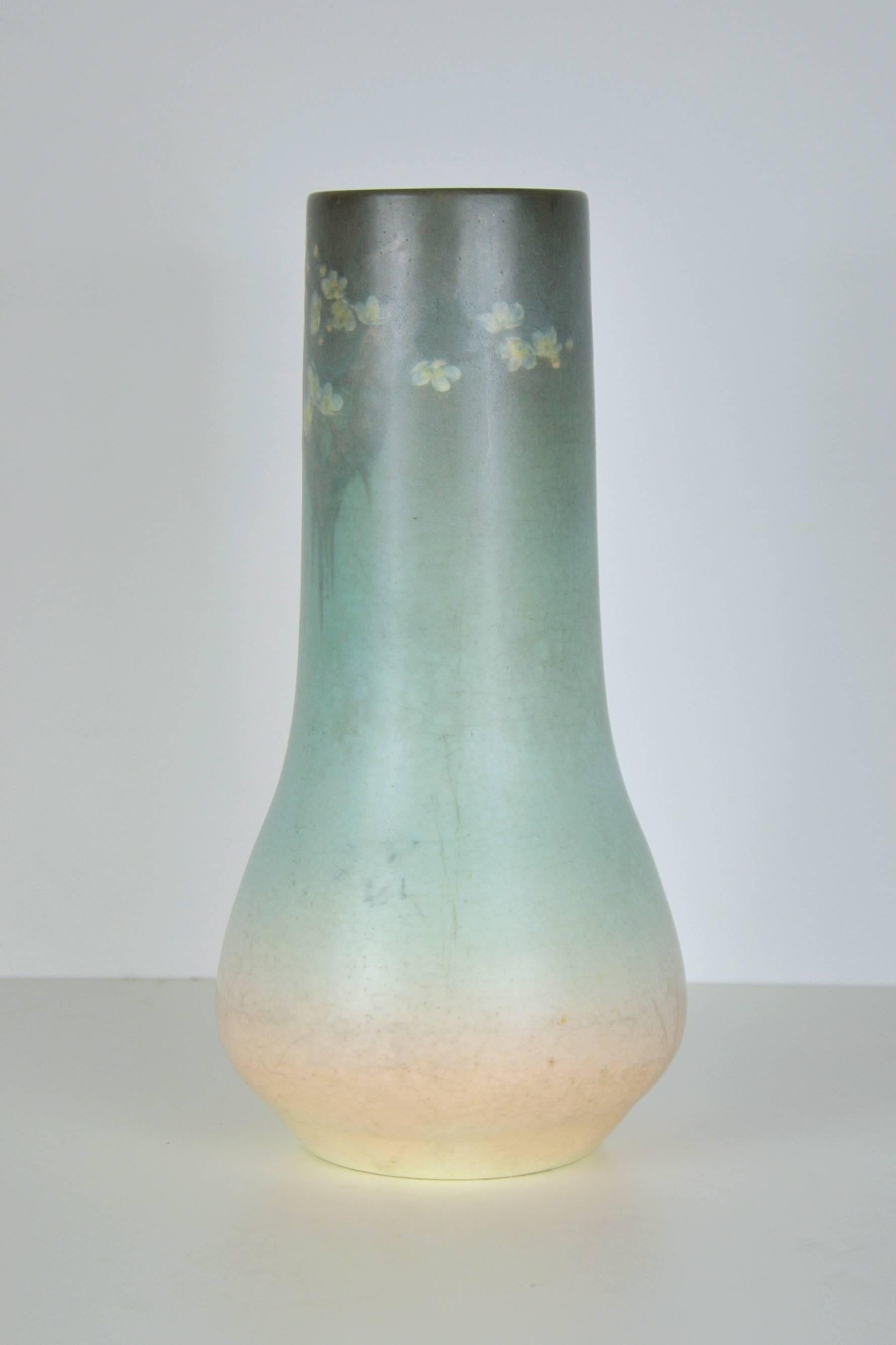 A beautiful example of a circa 1910 Rookwood pottery vase decorated by the renown artist Edward Timothy Hurley (Ohio, 1869-1950). The gourd shaped vase is finely hand-painted with flowering branches and features colors from pale pink, pastel blue to