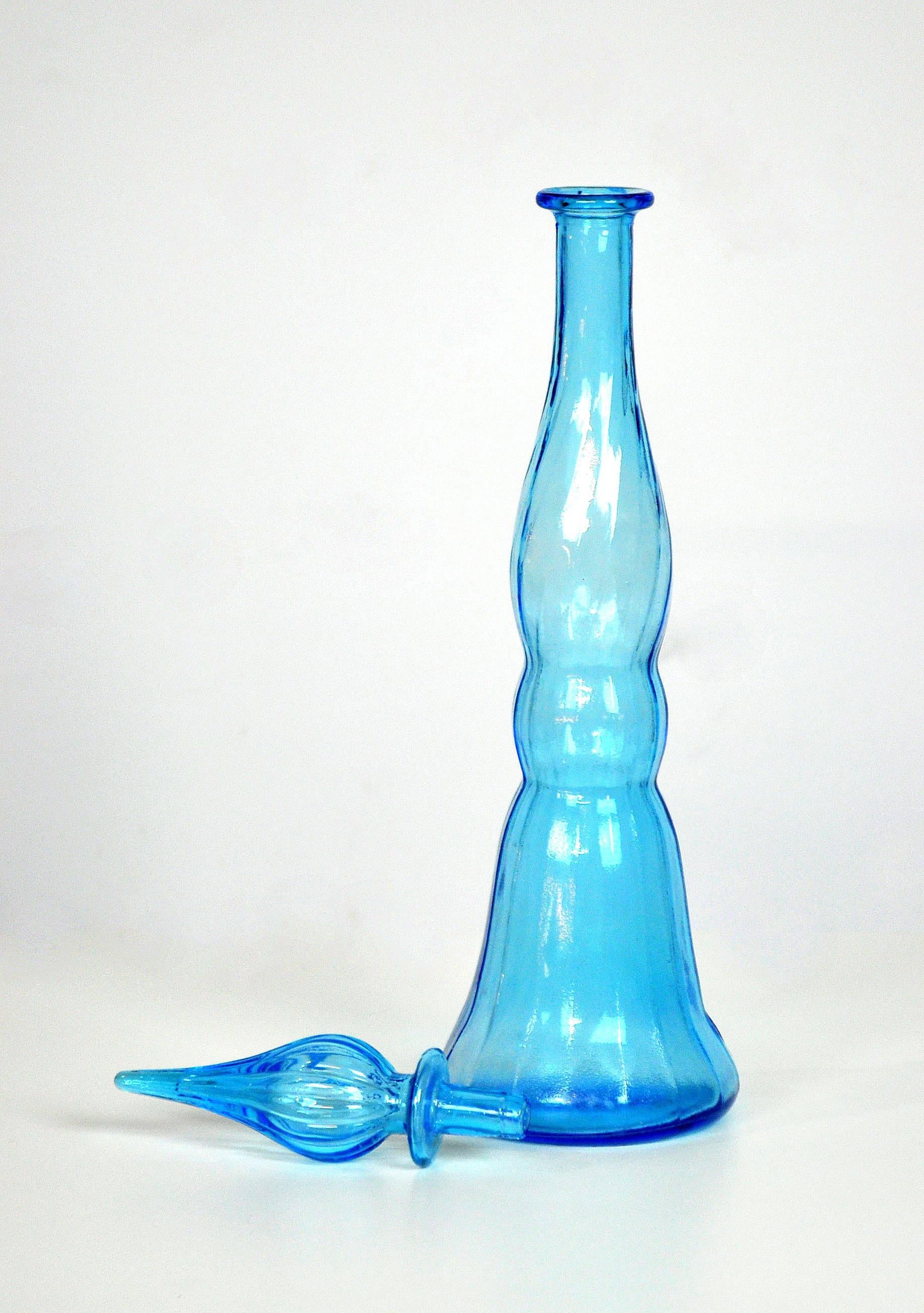 This vintage Mid-Century Modern large handblown glass genie bottle features a line pattern and a vibrant light or baby blue color. The bottle with stopper dates from the 1960s and was made in Italy. Quite tall and very decorative, it could accent