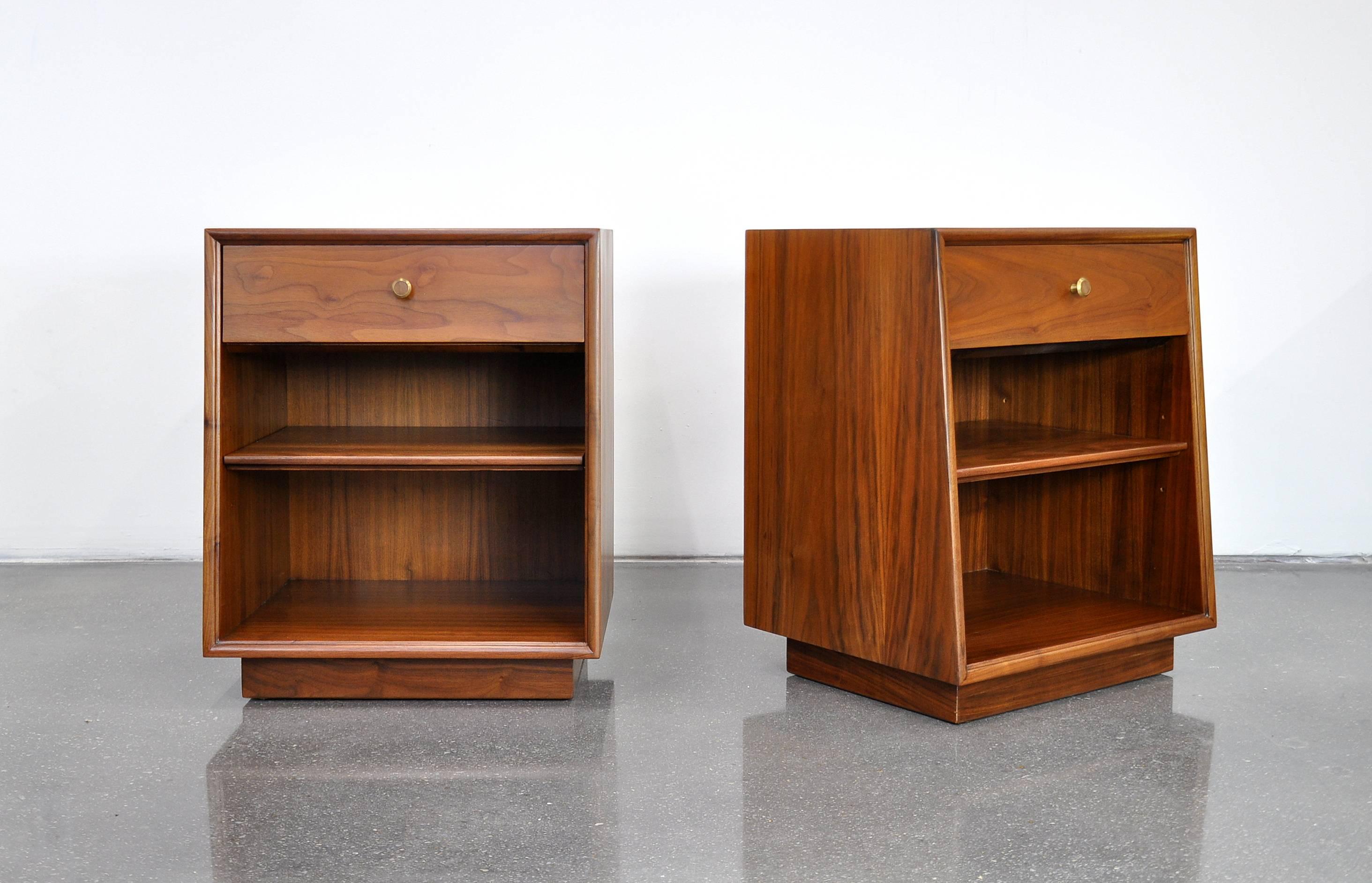 A very nice pair of Mid-Century Modern vintage nightstands designed by Kipp Stewart and Stewart MacDougall for the Drexel Declaration line in the 1960s. Each bedside table features a drawer with original pull over an adjustable shelf and provides a