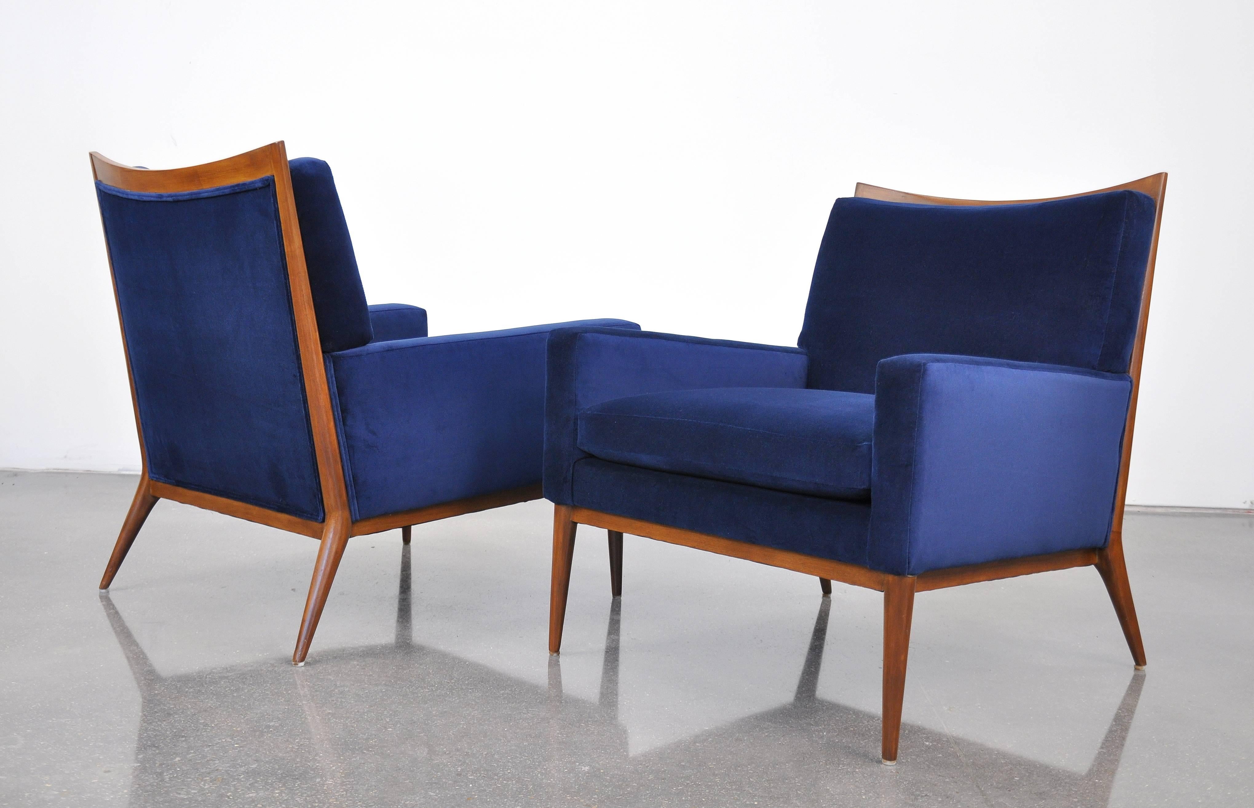 Exquisite pair of Mid-Century Modern model 1322 armchairs from the coveted Directional collection, dating from the 1950s. The refinished chairs have been recovered in a stunning deep and mesmerizing sapphire blue 100% cotton velvet. The beautifully