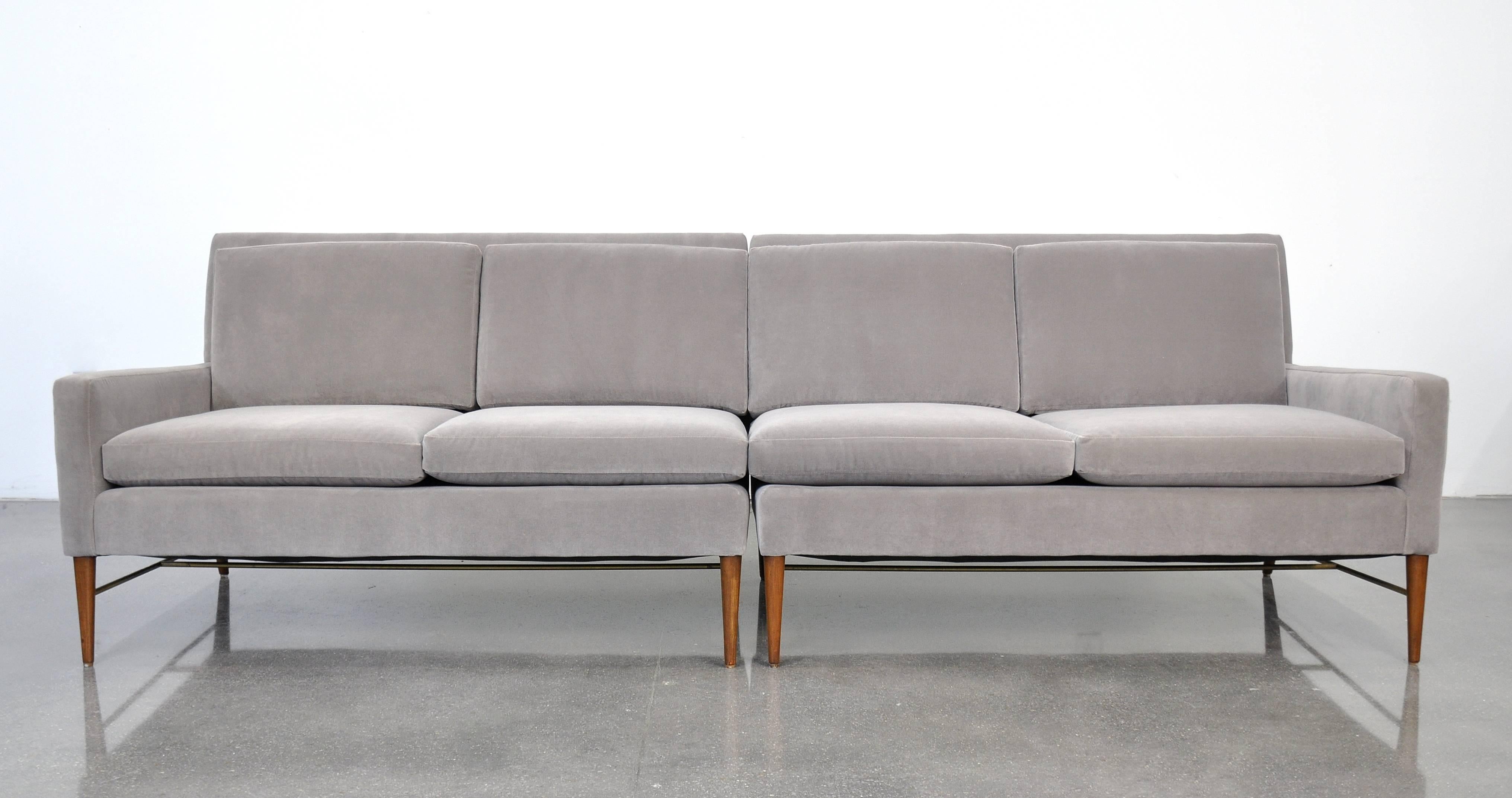 Exquisite pair of Mid-Century Modern model 5004 settees from the coveted Directional collection, dating from the 1950s. The reupholstered two-piece couch has been recovered in a stunning light gray 100% cotton velvet. The beautifully sculpted