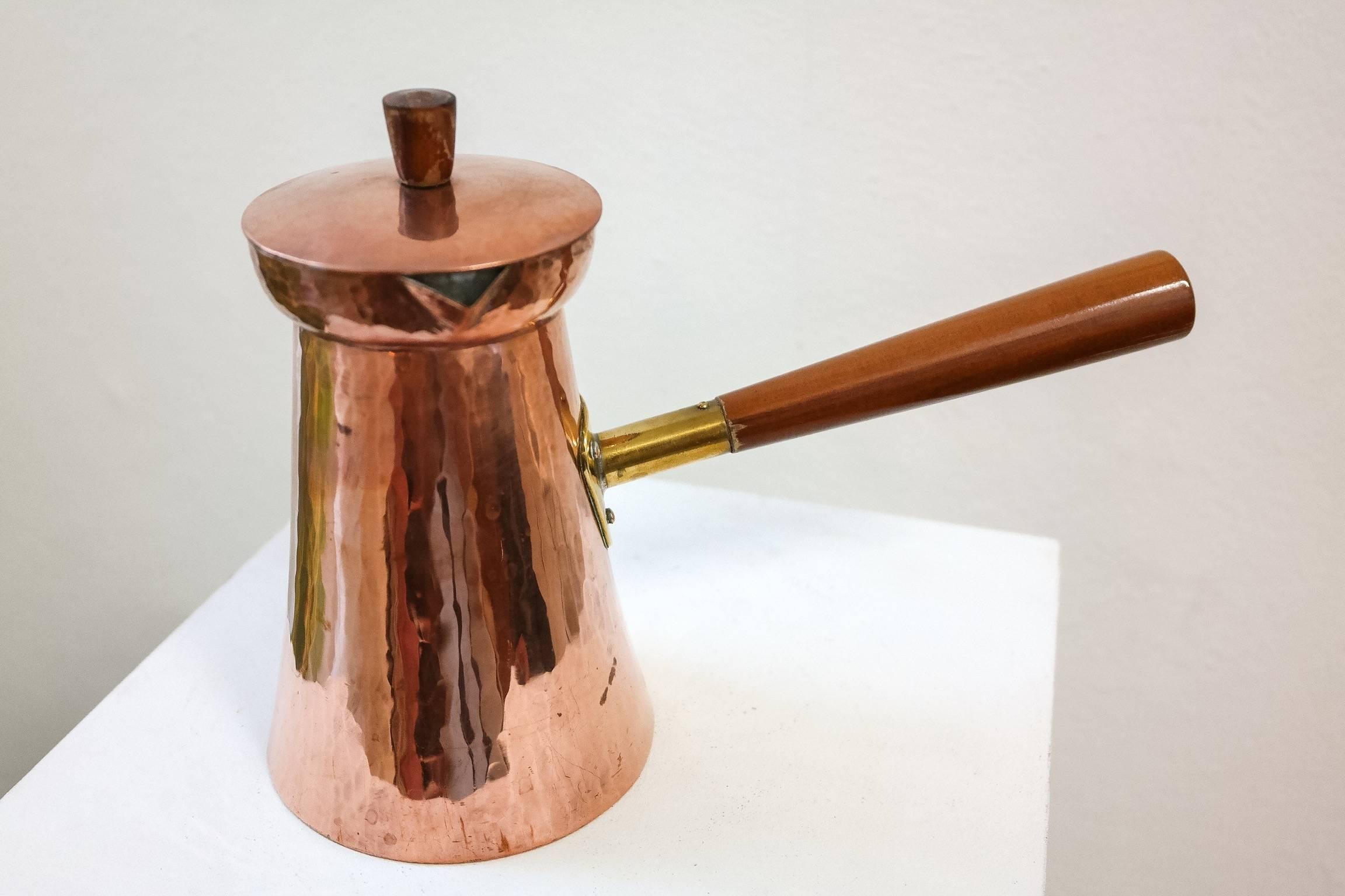 This coffee pot is made of copper and is tinned from the inside. Created by Karl Raichle, this object has the original hallmark on the bottom.