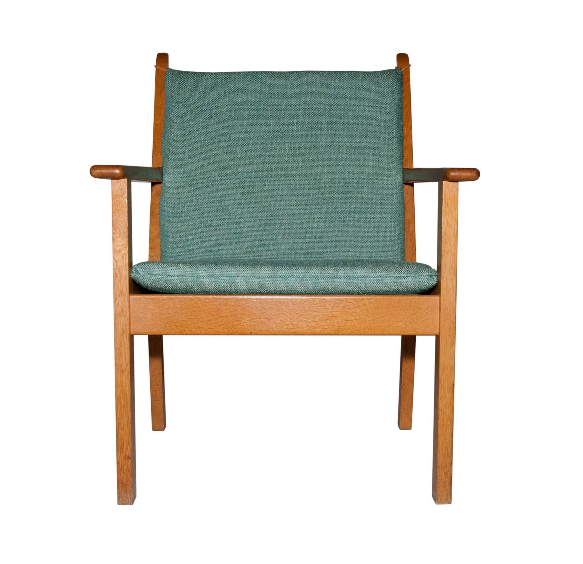 Vintage oak frame lounge chair designed by Hans J. Wegner for GETAMA, Denmark. Original cushion, with light wear. Marked. Measures: Arm 23" H.