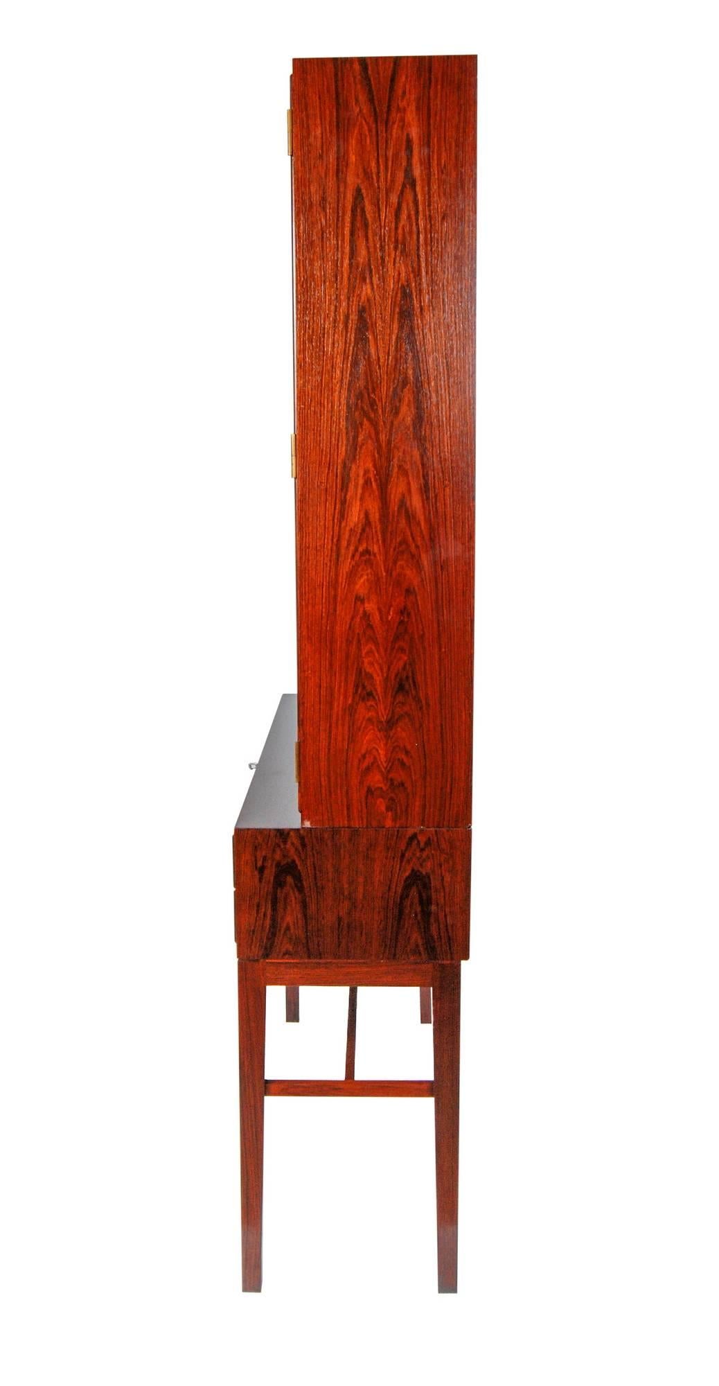 Rare vintage Danish rosewood two-piece glass front cabinet designed by Svend Langkilde for Illums Bolighus, 1960s. The base has five drawers that are all rosewood constructed including the dovetails, all the locks are functional and the key is