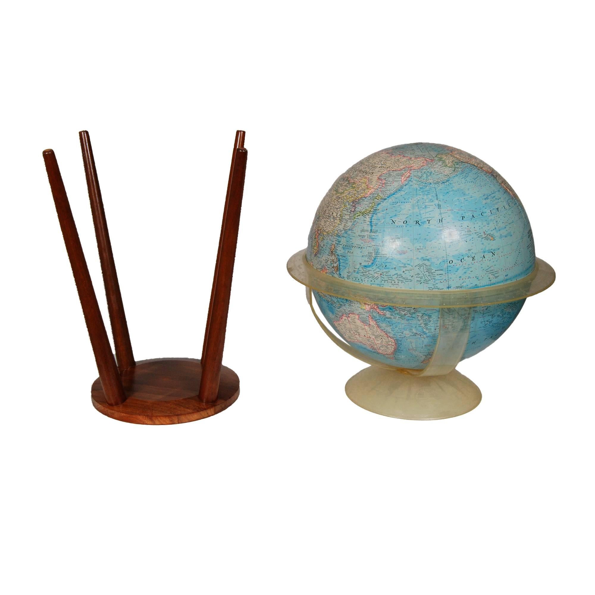 Vintage National Geographic floor globe on a walnut stand. The globe sits in an acrylic holder and measures distance. Base is a spider-leg walnut stand with a groove to hold the acrylic holder in place. Marked.