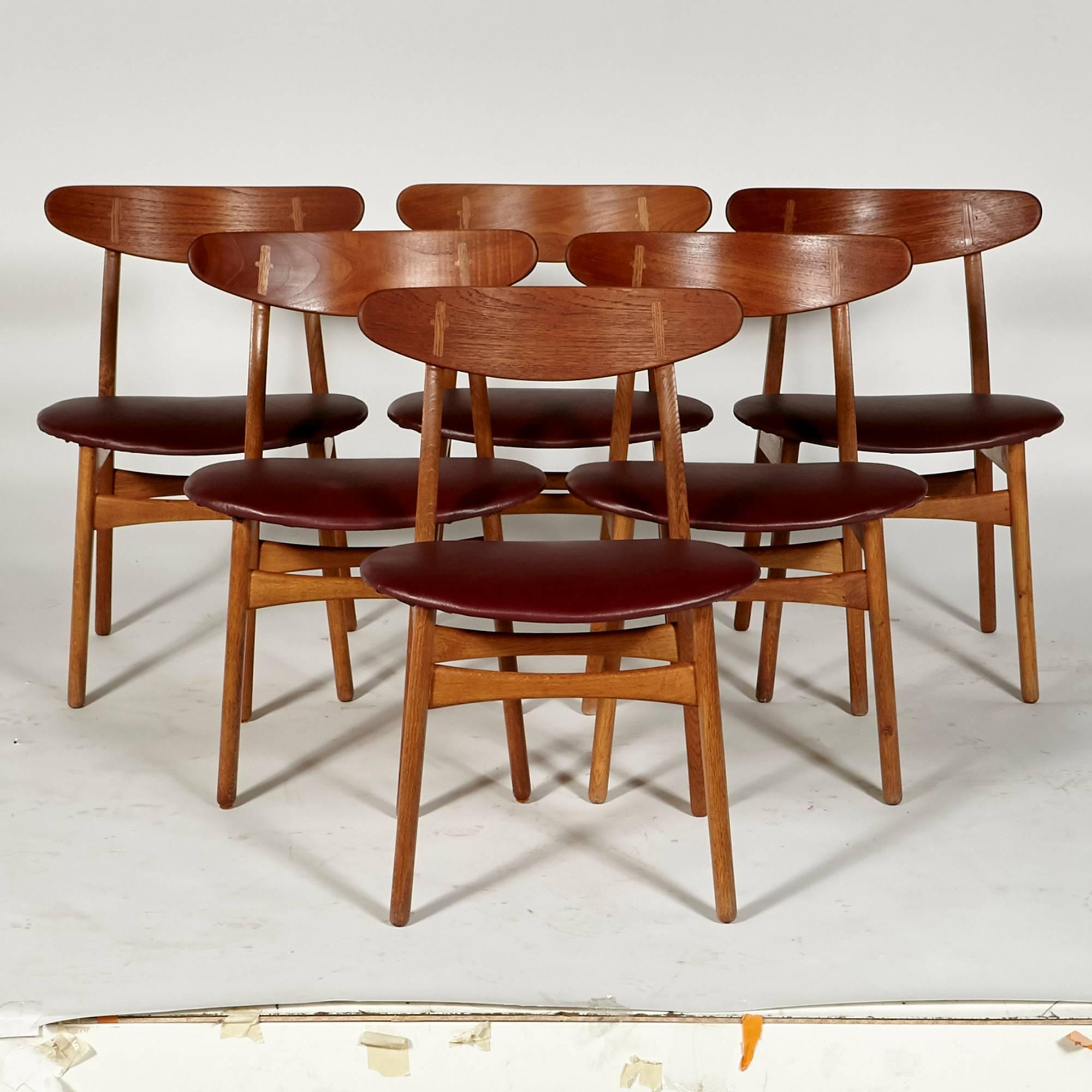 Vintage Danish early 1950s Hans J Wegner for Carl Hansen & Son, set of six CH-30 teak dining chairs with Merlot leather seats. Excellent condition. Unmarked.