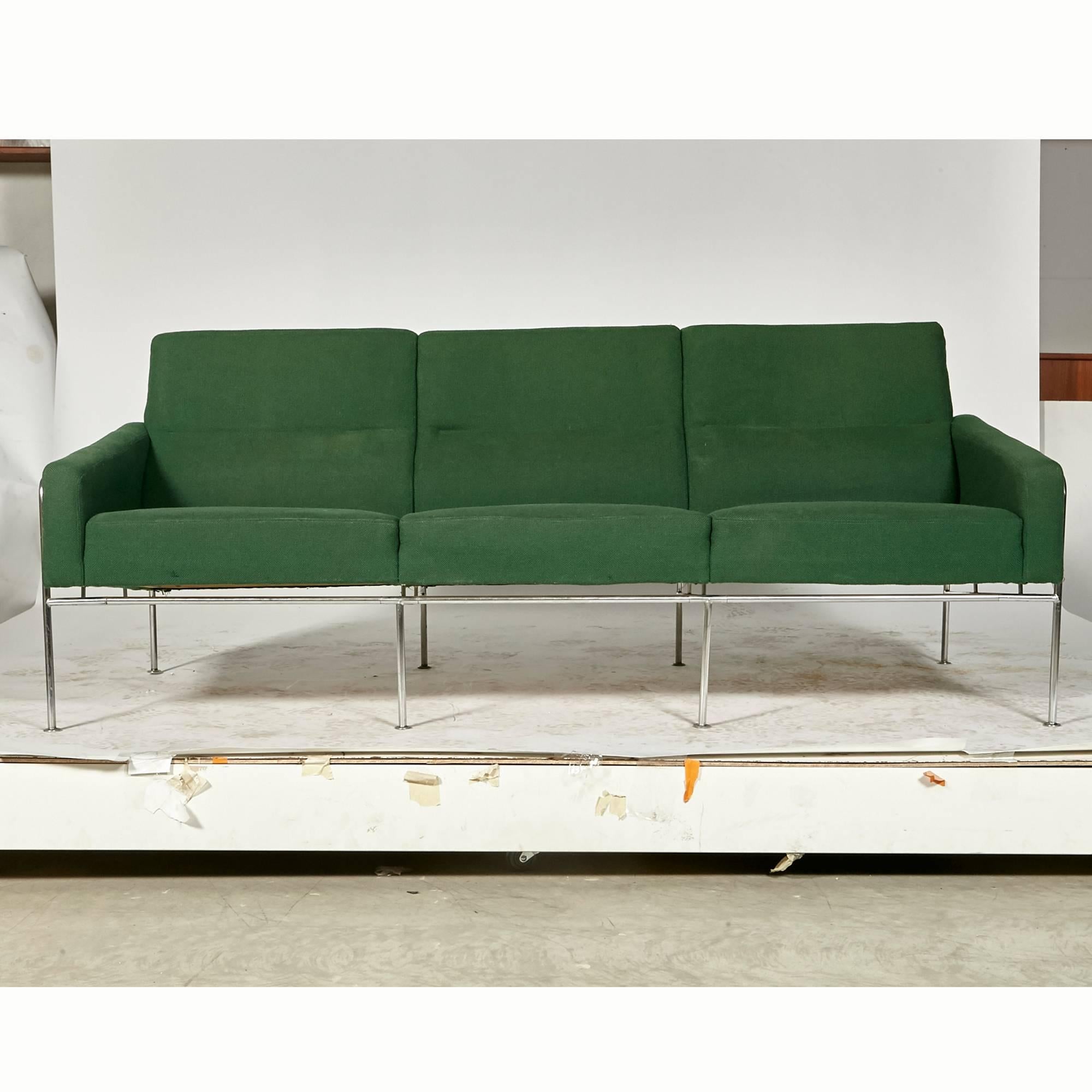 Original Danish three-seat airport sofa model 3300/3 designed by Arne Jacobsen for the SAS Royal Terminal in 1957 for Fritz Hansen. Sofa is on a chrome base with original green fabric. Marked.  Engraving of the School's Name that the Sofa Came From