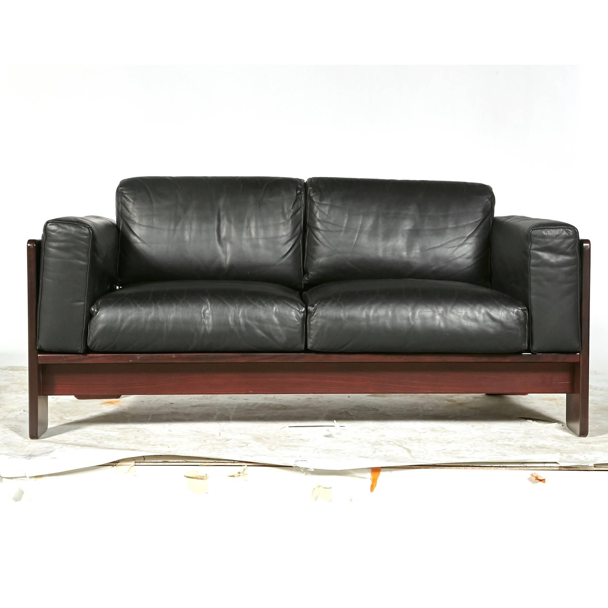 1960s Bastiano two-seat sofa in rosewood and black leather by Tobia Scarpa for Knoll. Measures: Arm is 23.5in H. Unmarked.

 