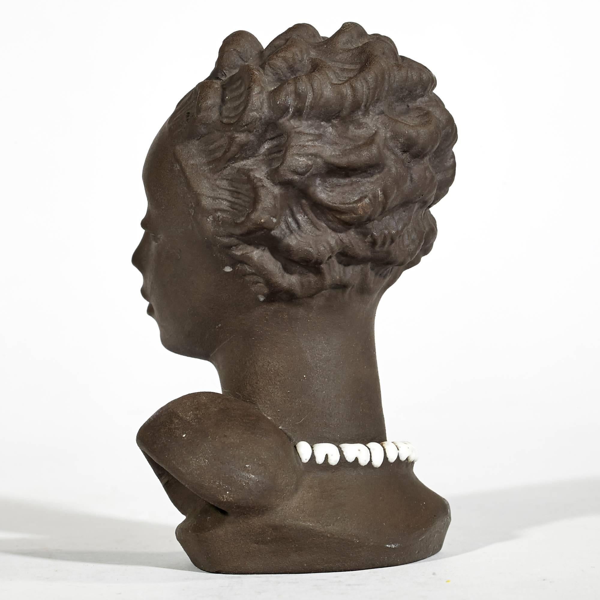 Vintage 1950s Marianne Starck designed black female bust with glazed white pearls on raw clay for Michael Andersen Studios, Bornholm Denmark. Possibly part of the "Tribal" line of pottery. Marked with the Studio shield and 4012-2