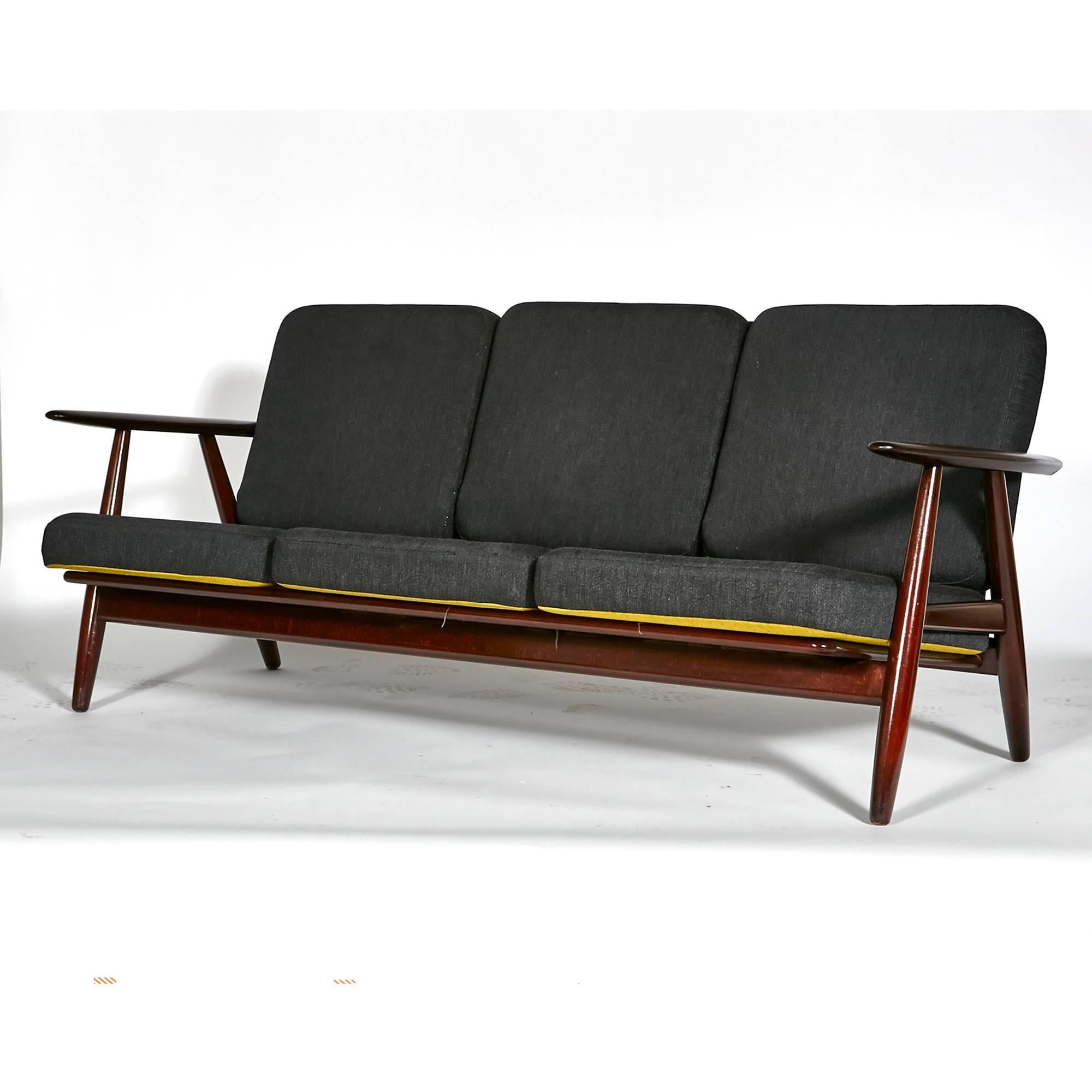 Vintage 1960s Hans J. Wegner for GETAMA Denmark cigar three seat sofa with reversible cushions. The sofa is in ash with a dark wood stain. Marked.