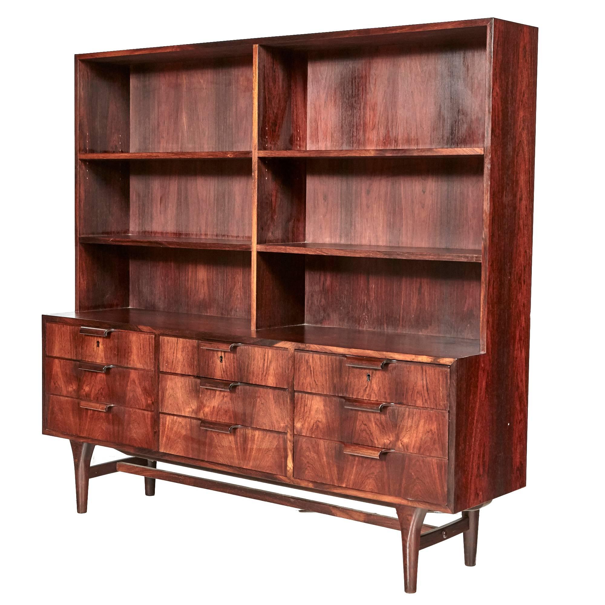 Vintage 1960s Danish storage cabinet in Brazilian rosewood with shelving and nine drawers. The drawer pulls are curved rosewood and the shelves are not adjustable. Unmarked but attributed to Gunni Omann.
