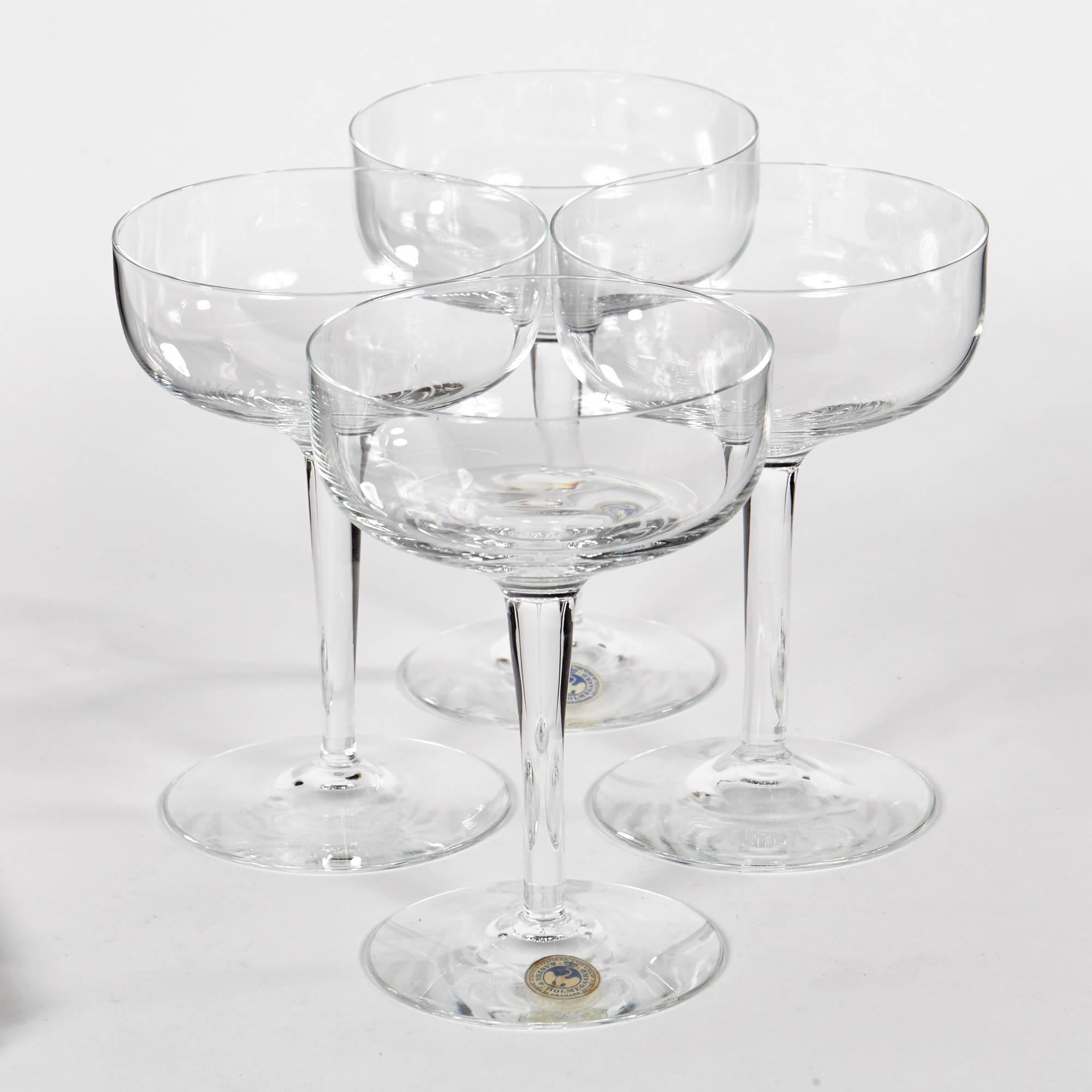 Vintage, 1960s Holmegaard of Denmark set of four clear glass coupe stems with the original stickers.