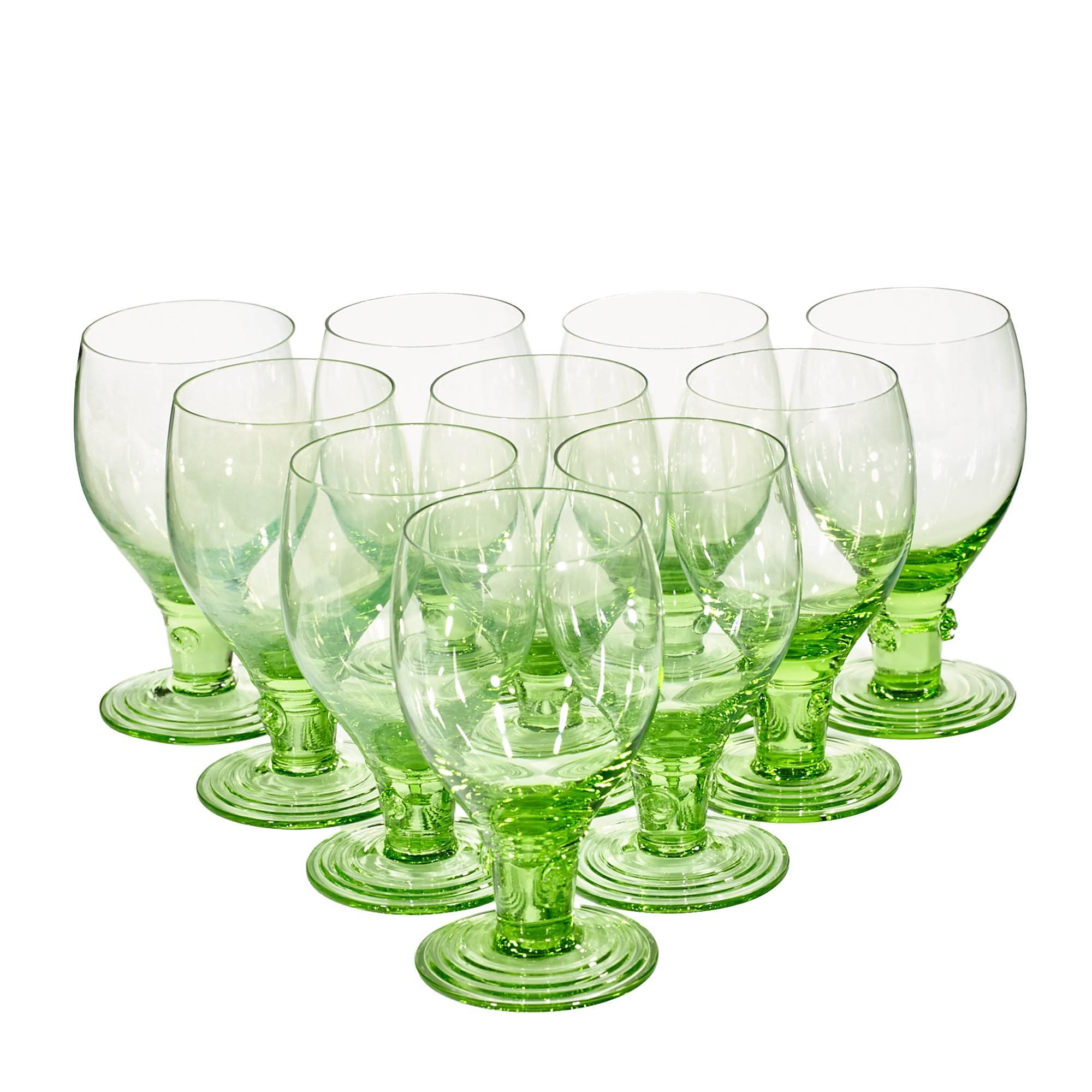 Vintage handblown set of ten-light green glass wine goblets with decorated stems, circa 1950.