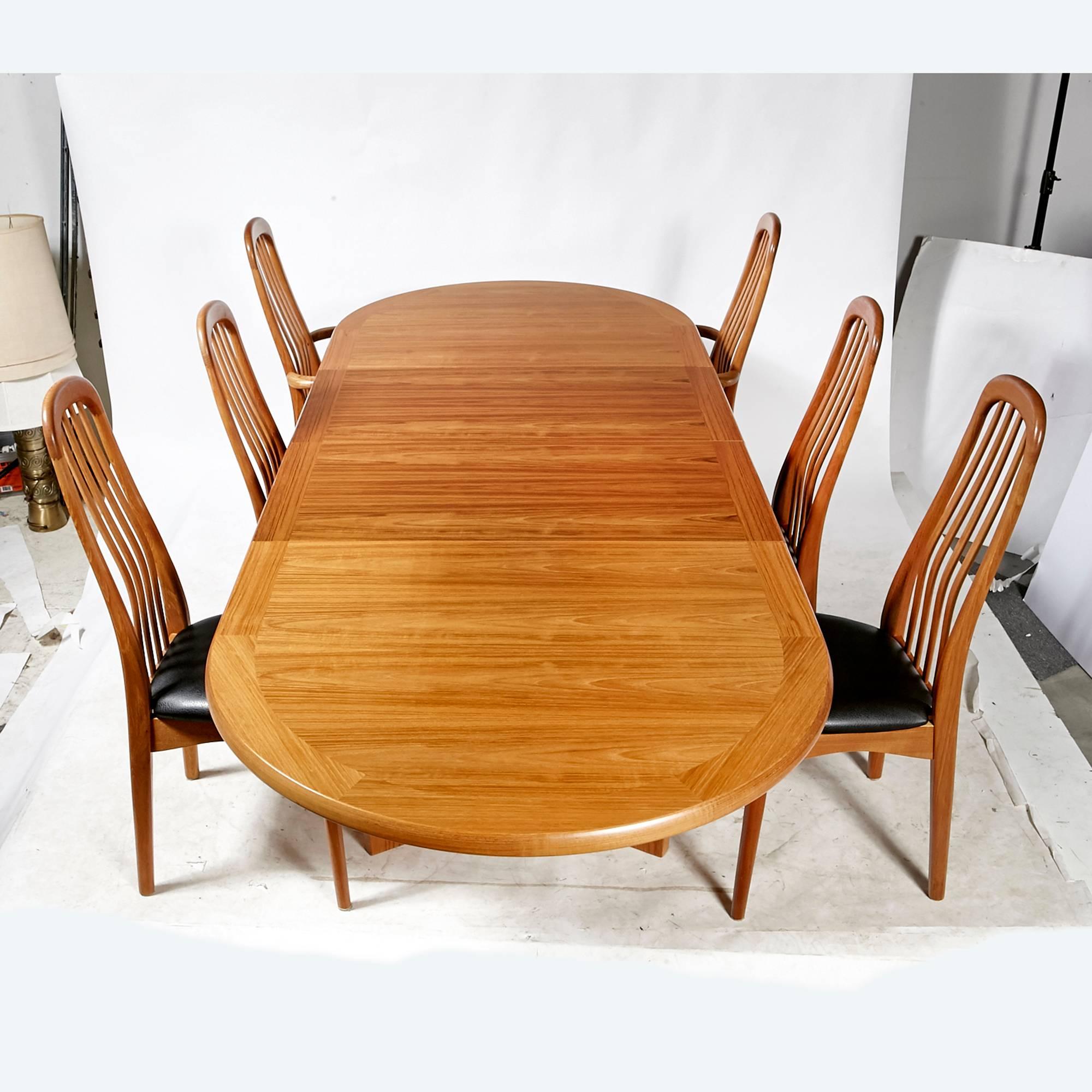 Vintage mid-20th century Scandinavian style Benny Linden teak dining room set with six chairs and the matching table. There are two-armed chairs and new black Naugahyde seats on all the chairs. Marked.
Measurements: Armchairs, 19in. D x 20in. W x