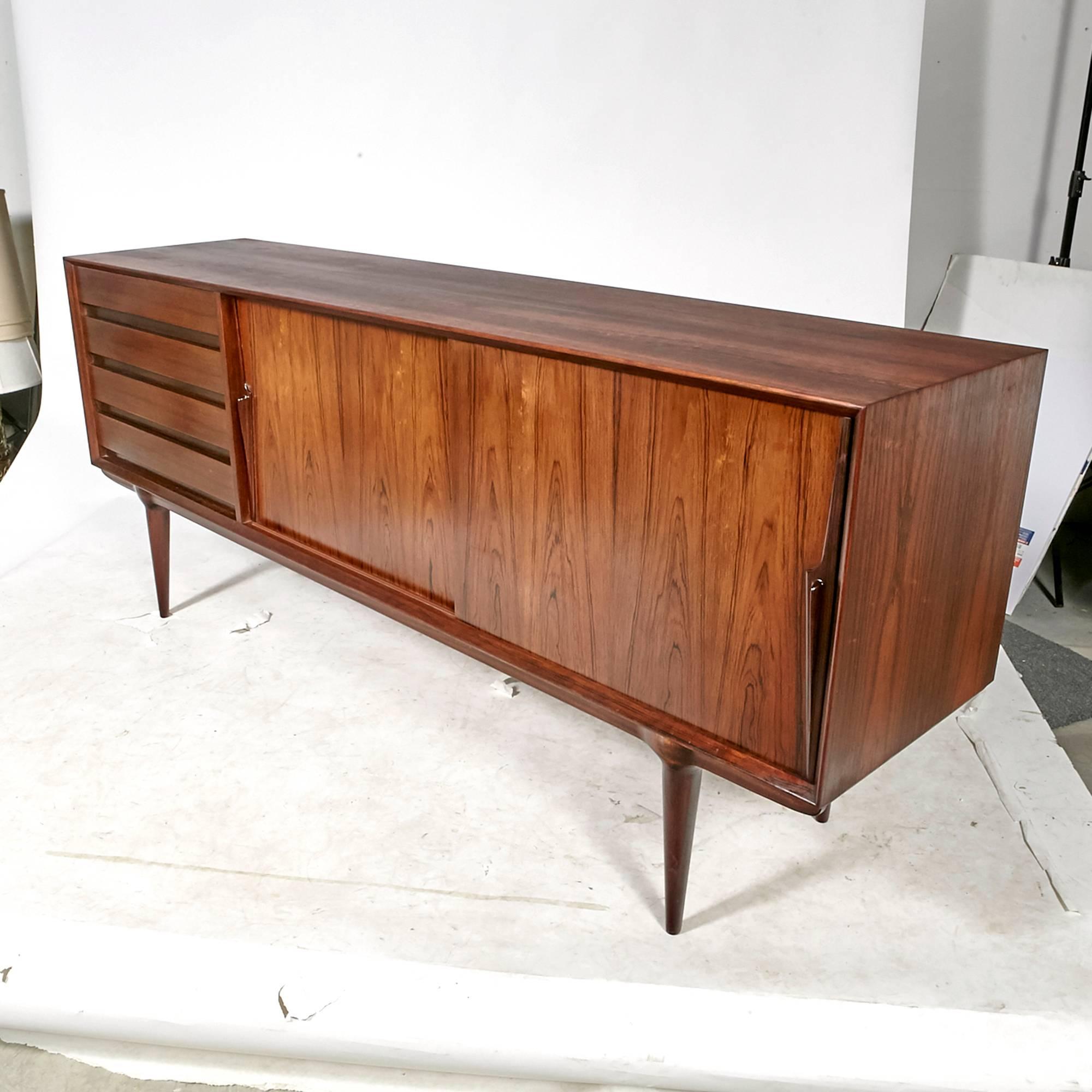 Vintage Scandinavian Modern Gunni Omann Model 18 Danish rosewood sideboard for Omann Jun Møbelfabrik, circa early 1960s. The sideboard has four drawers and shelving for storage. Beautiful original condition. Unmarked.