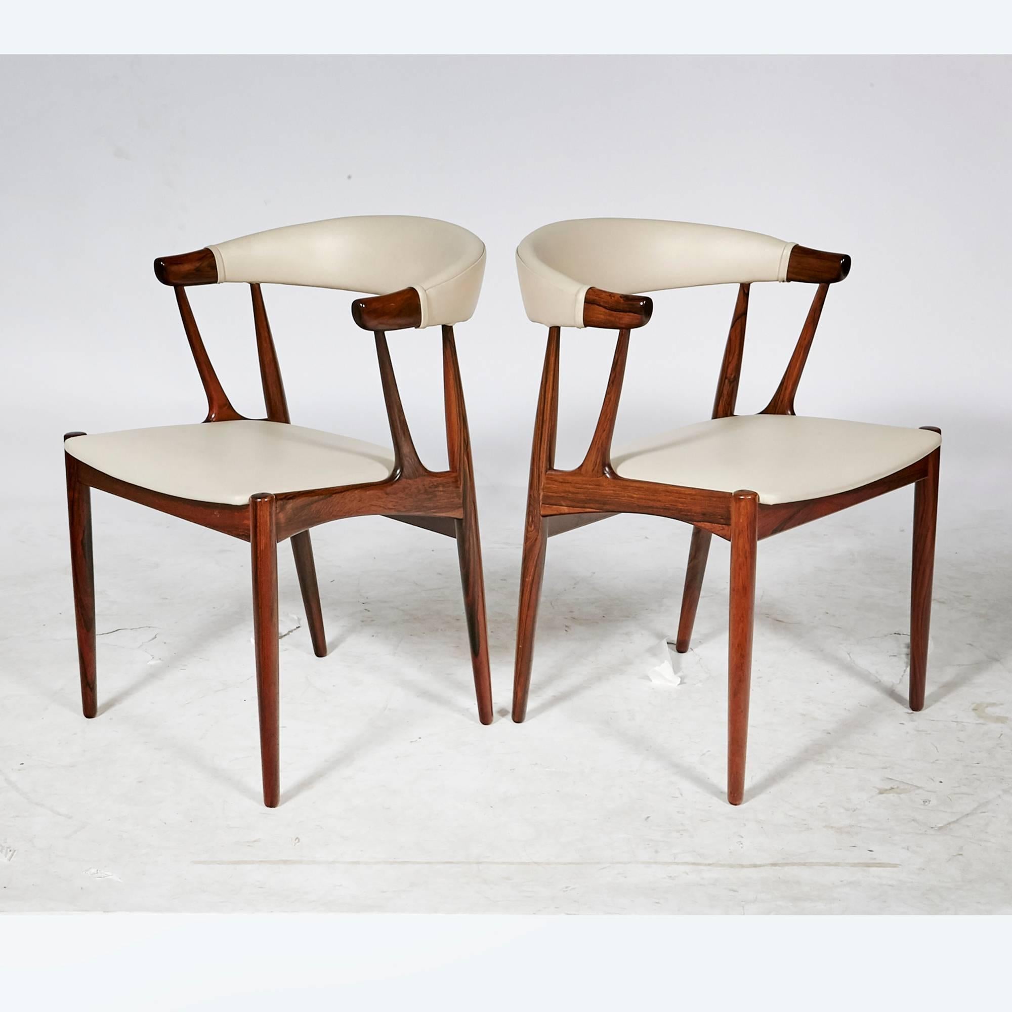 Vintage Scandinavian Modern Danish rosewood set of six dining chairs by Johannes Andersen, circa 1960s. The chairs are model BA113 with the original leather on the chairs. Some wear to leather in spots. Measure: Arm height, 27in.H. Marked.