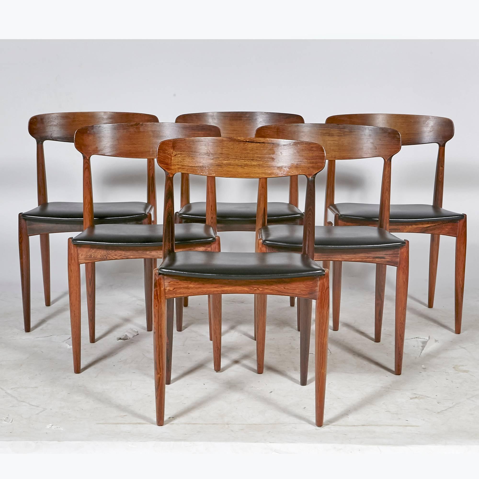 Vintage Scandinavian Modern set of six Danish rosewood dining chairs by Johannes Andersen for Uldum Mobler, 1960s. Refinished condition and new black Naugahyde seats. Marked underneath.