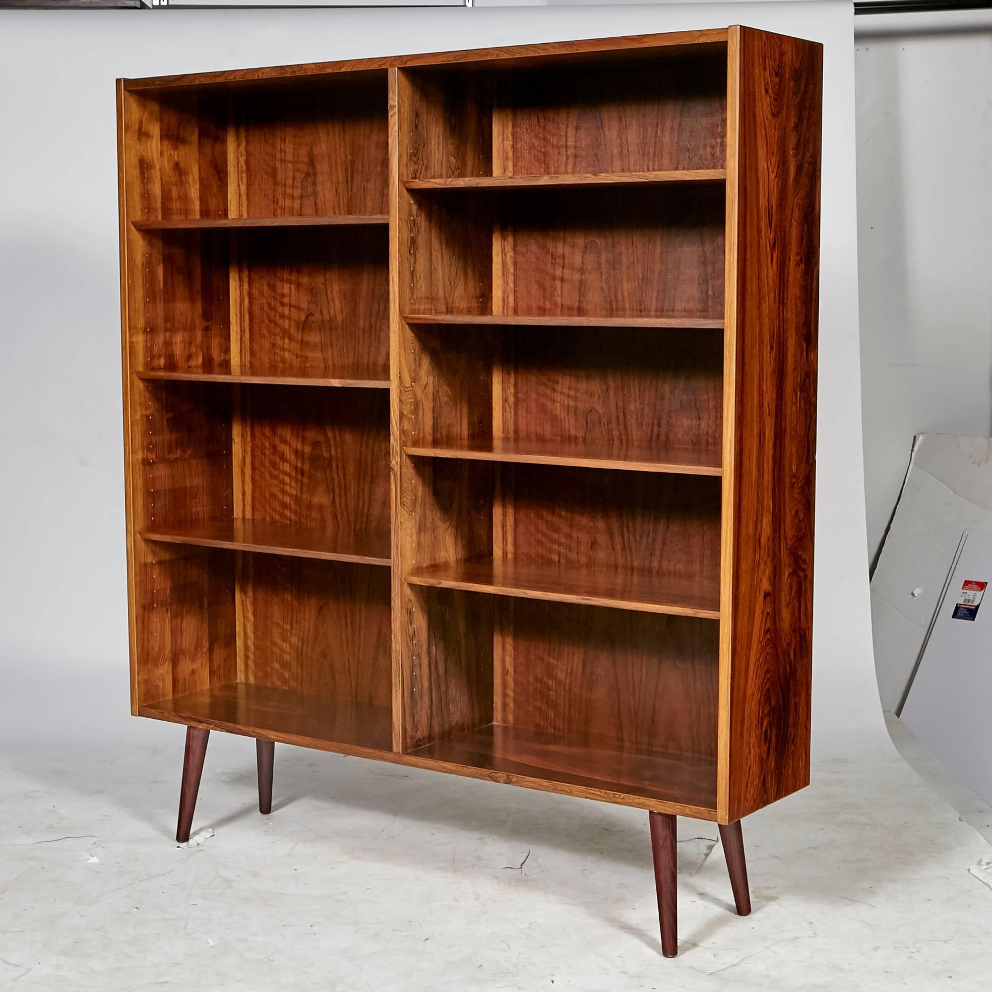 Vintage Scandinavian Modern Danish rosewood bookcase by Edmund Jørgensen, circa 1960s. The bookcase shelving is adjustable with angled round legs. Marked.