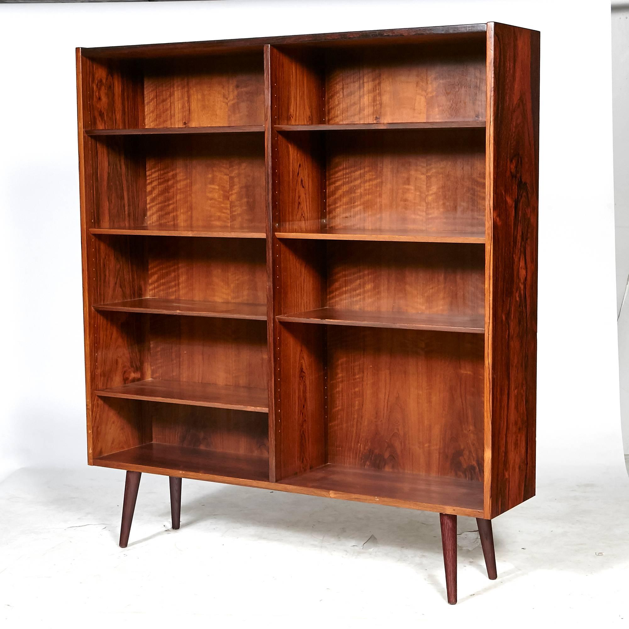 Vintage Scandinavian Modern Danish rosewood bookcase with adjustable shelving and angled round legs. Unmarked.