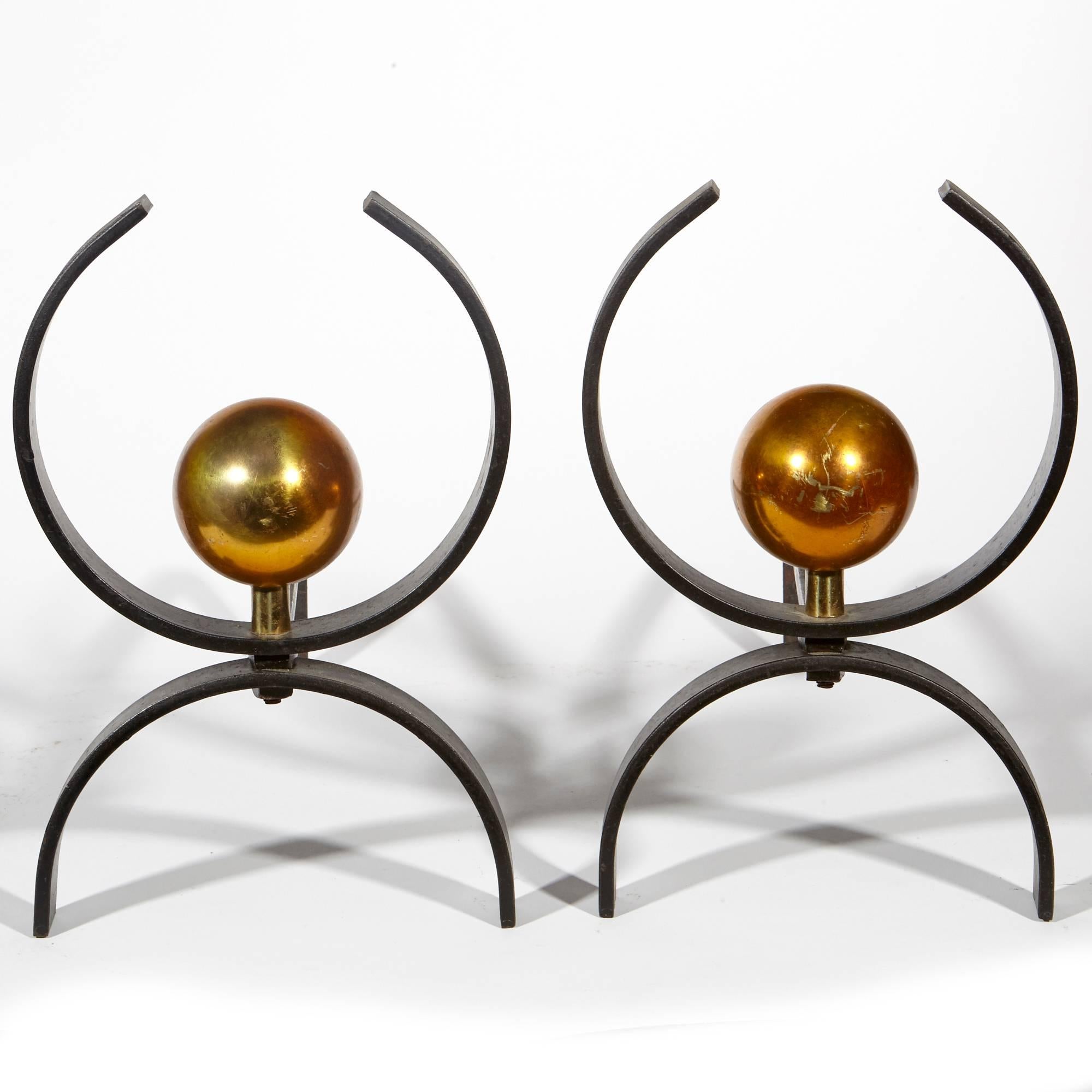 Vintage 1950s black and gilt metal andirons designed by Donald Deskey.