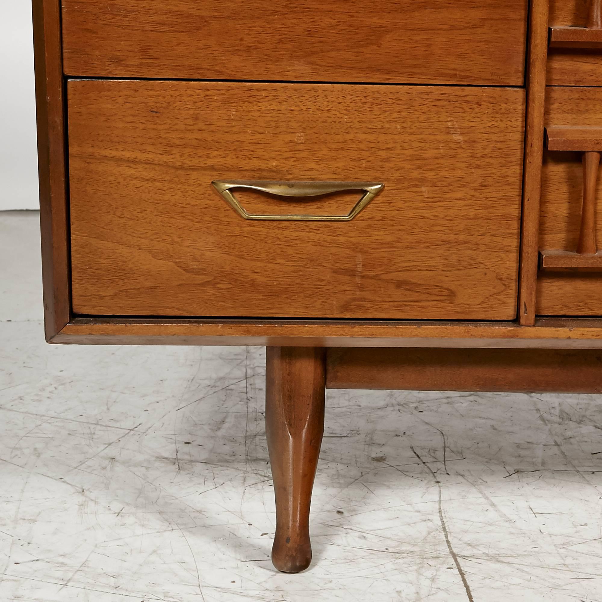 1960s Unagusta walnut wood nine-drawer low dresser with brass pulls. The dresser is newly refinished. Marked.