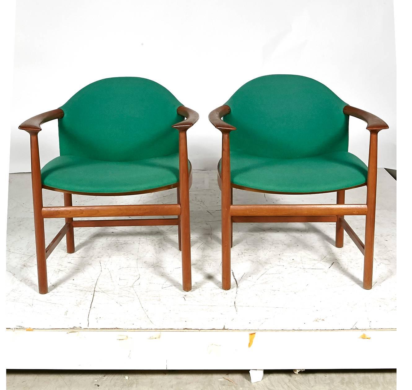 Danish pair of sculpted teak armchairs with original fabric. Arms, 27in.H. Seat, 17in.H. Unmarked.