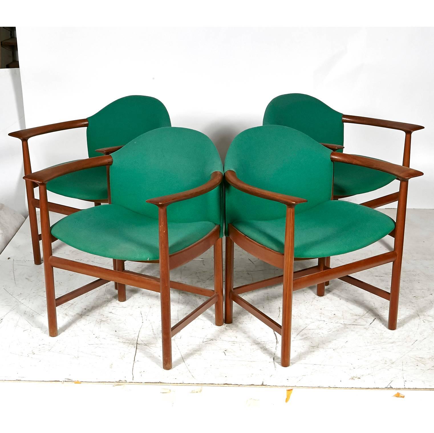 Danish set of four sculpted teak armchairs with original fabric. Measures: Arms 27 inches H, seat 17 inches H. Unmarked.