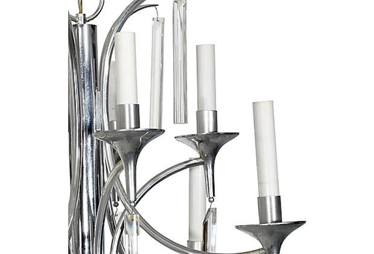 Ten-arm chrome chandelier with glass prisms designed by Gaetano Sciolari for Lightolier, circa 1960. Hardwired; uses low wattage chandelier bulbs. Chain, 7" L. Marked.

 