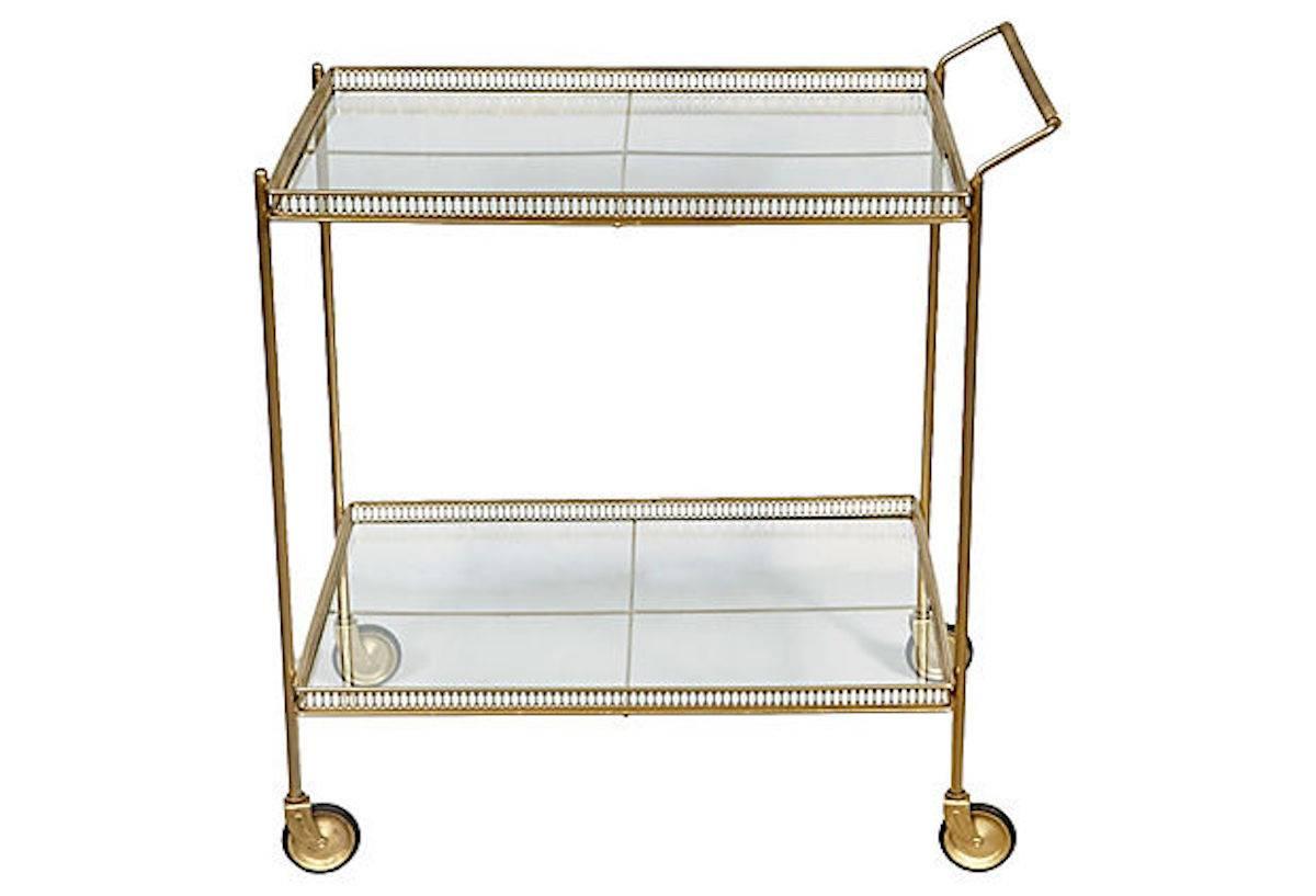 1960s gilded metal rolling serving or tea cart with two glass shelves. Newly refinished with new glass. Unmarked.
 
