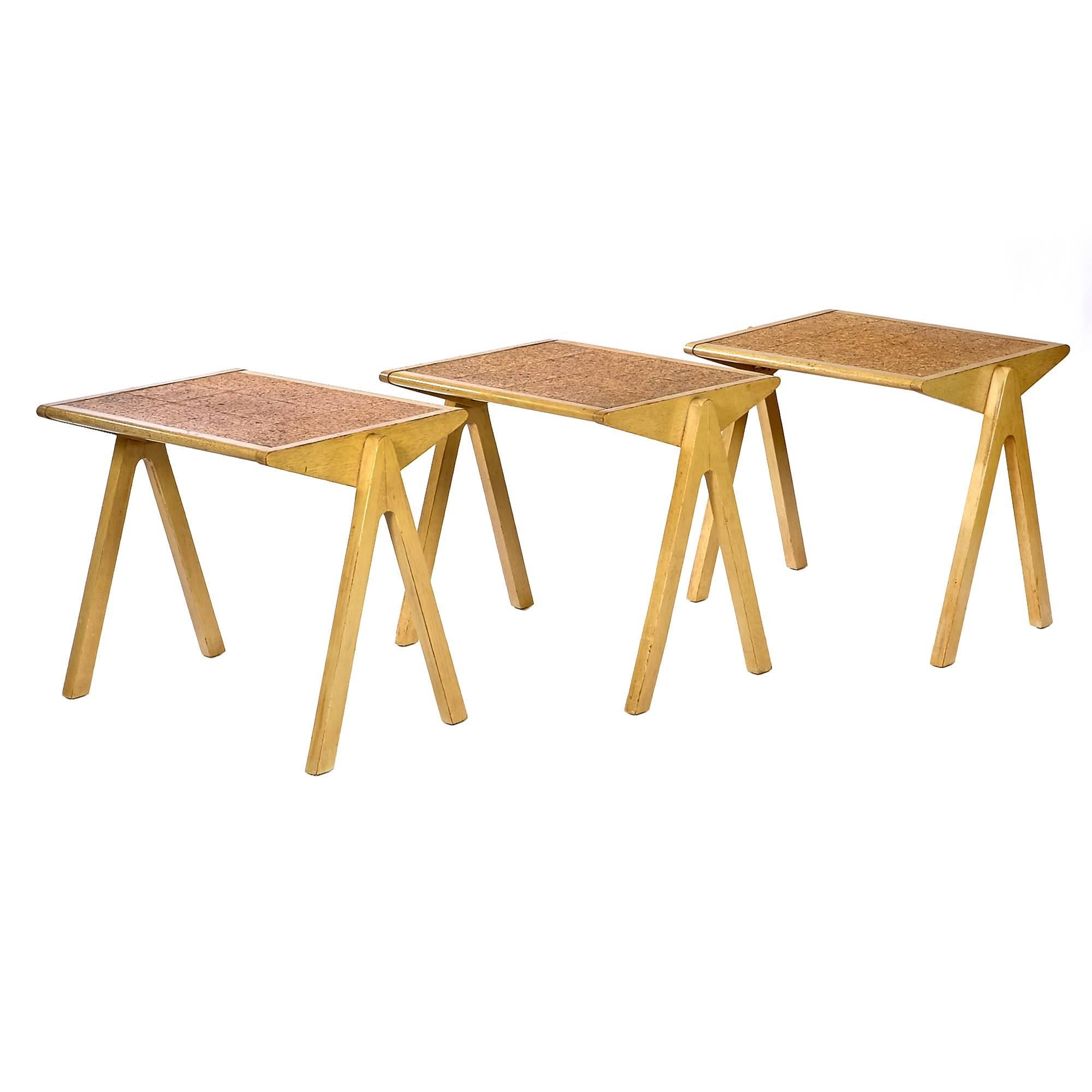 Rare set of three stacking tables with bleached mahogany wood, cork tops and splayed compass-style legs. Tables are designed by Bob Roukema for Jon Jansen of New Zealand, 1953.