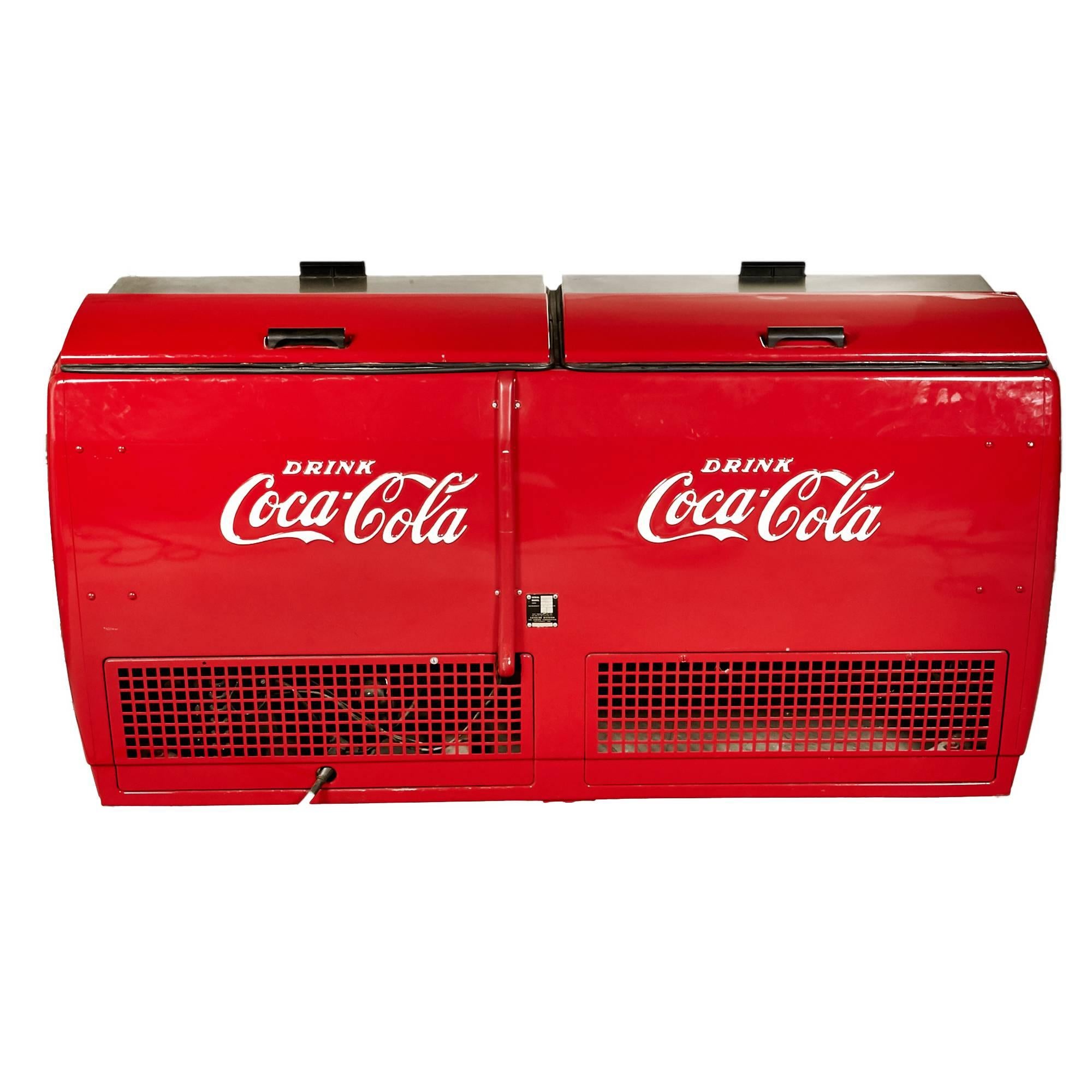 Late 1960s coca cola soda ice cold chest holds 22 cases of soda and is in working condition. The chest was restored about 10 years ago with a new compressor, cord and fully re-wired. The chest loads from the top and has a soda cap remover in front.