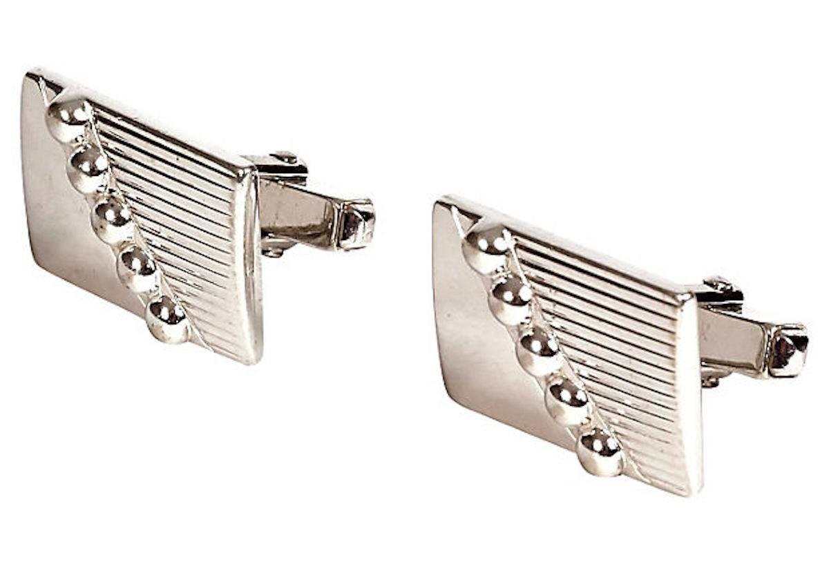 Pair of 1960s men's Silvertone rectangular line and ball designed cuff links.
 