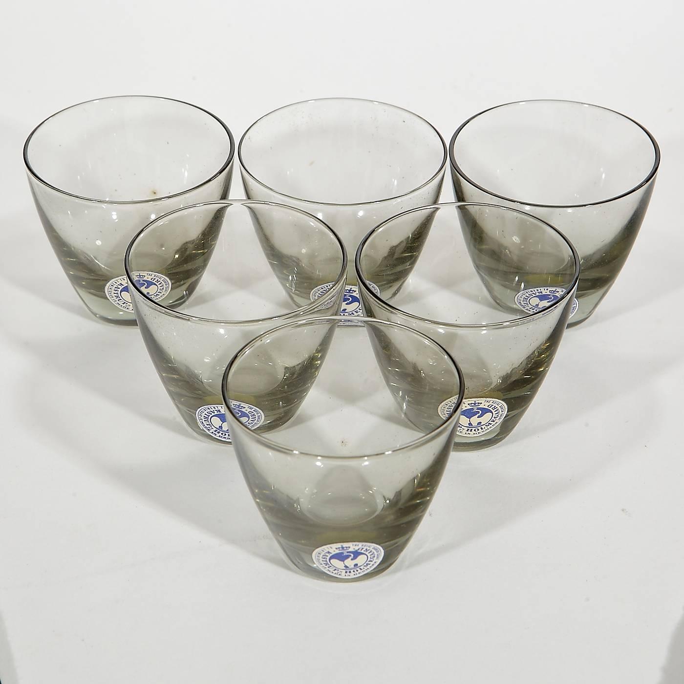 Vintage Holmegaard of Denmark, 1960s set of six glass smoked 1 1/2 oz whiskey tumblers in the original box and in unused condition. The set includes the box.