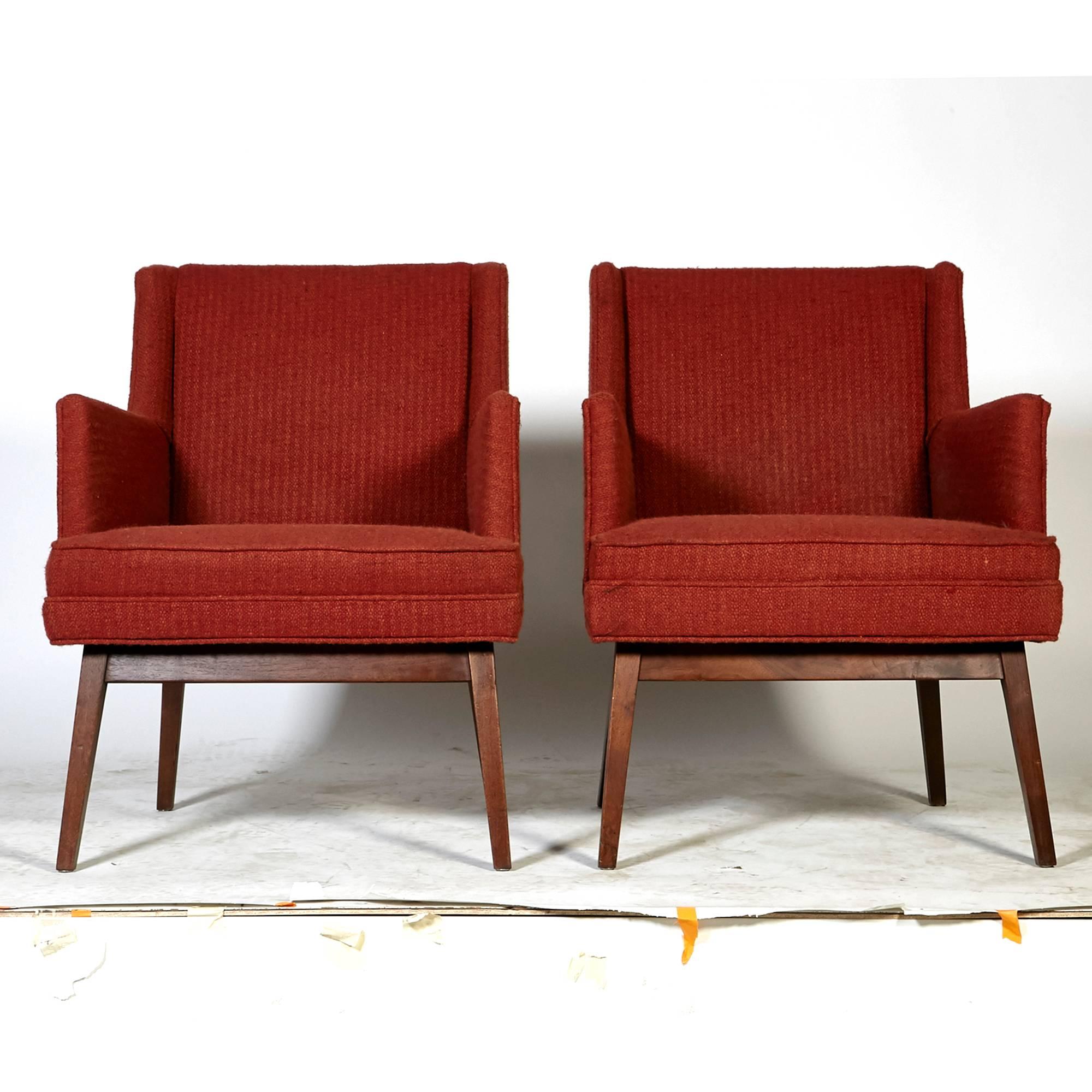 Vintage pair of walnut frame Jens Risom-style lounge chairs with the original fabric. Measures: Arm is 25.75