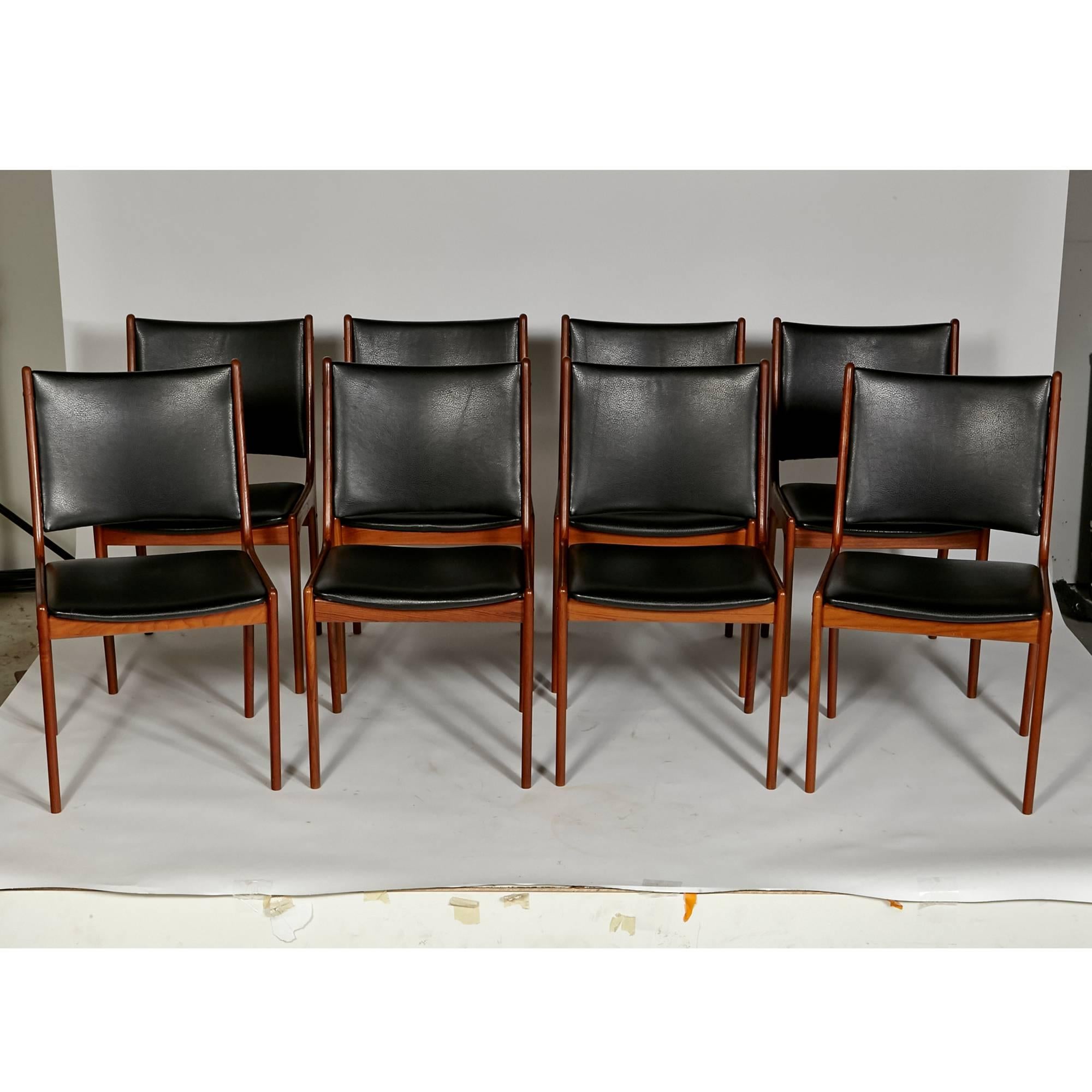 Vintage set of eight teakwood dining chairs. The chairs are newly refinished with new black textured Naugahyde seats and backs. Excellent condition. Unmarked.