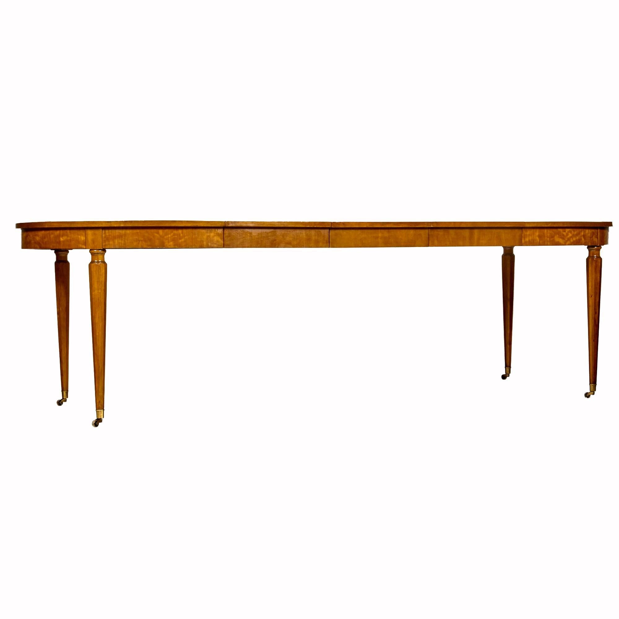 Vintage 1960s matched cherrywood banquet-style dining room table with the Belvedere finish by Kindel Furniture Co. Tapered and fluted table legs on brass castors. The table has three leaves 16in.W each. The table is 100in.L fully open. Marked.

 